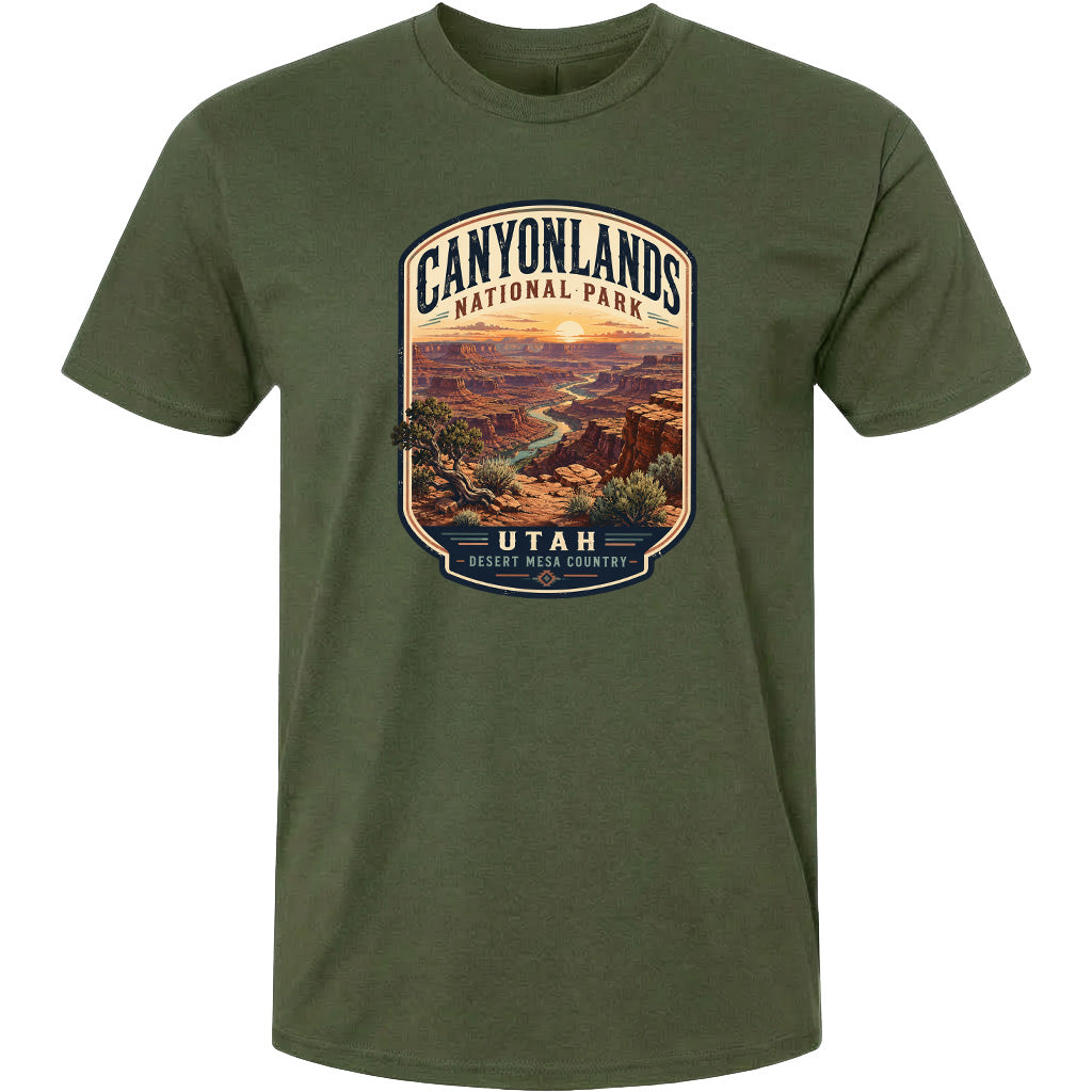 A t-shirt design featuring a scenic landscape with mountains, valleys, and a sunset. The text on the t-shirt reads "CANYONLANDS NATIONAL PARK" and "UTAH", indicating the location and the name of the national park.