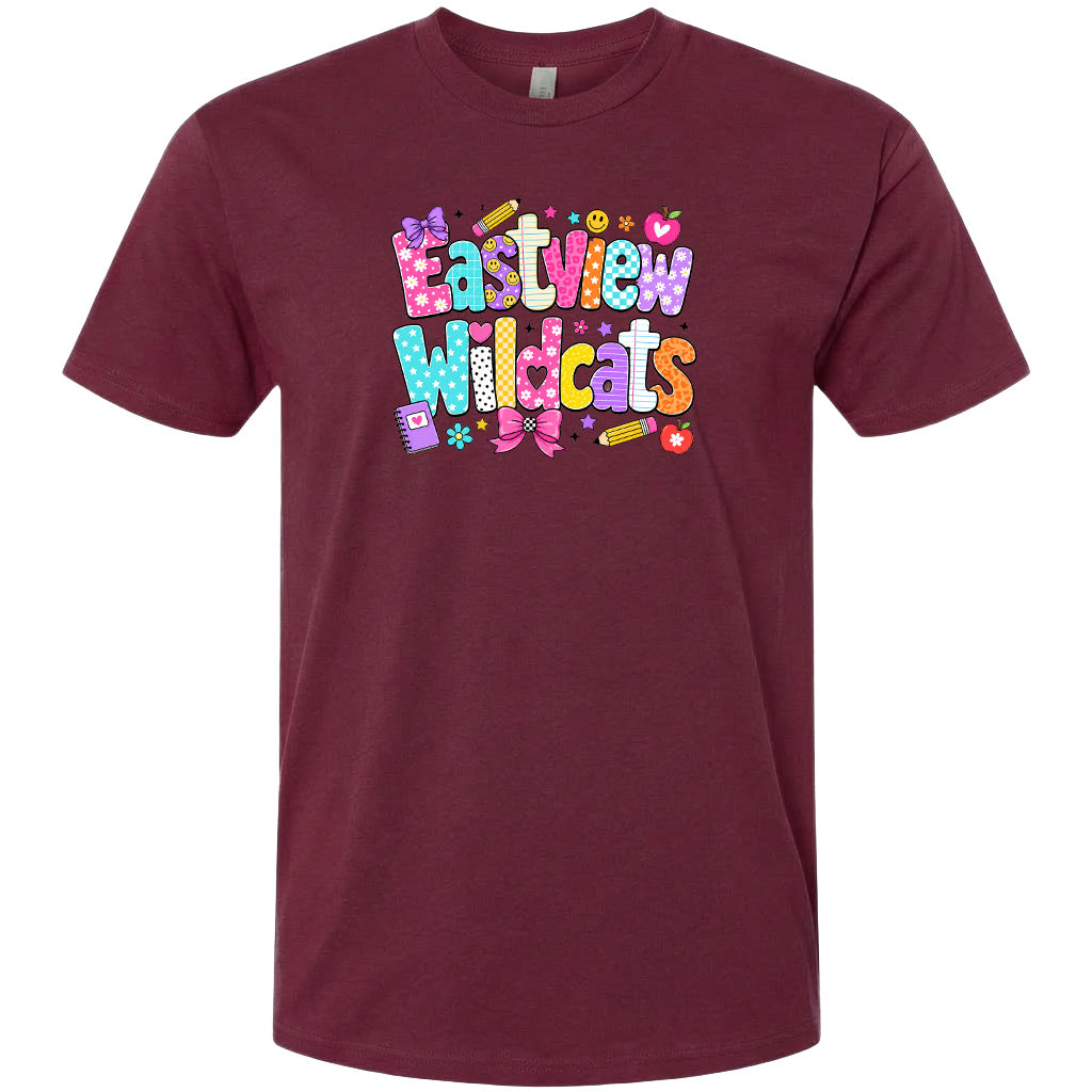 A burgundy-colored t-shirt with a colorful graphic design featuring the text "Eastview Wildcats" in a playful, cartoon-like font.