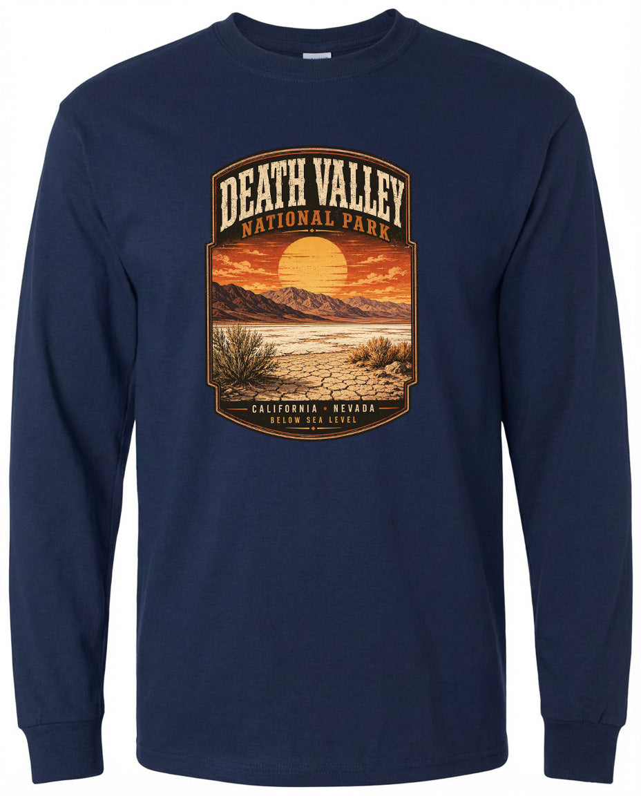 A long-sleeved navy blue t-shirt with a graphic design depicting a desert landscape with mountains, a sunset, and a desert plant.