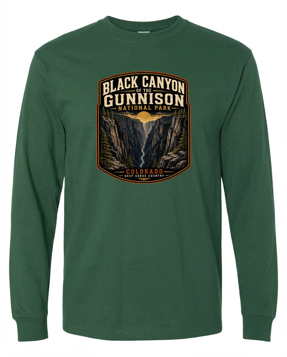 A green long-sleeved t-shirt with a graphic design depicting the Black Canyon of the Gunnison National Park in Colorado.