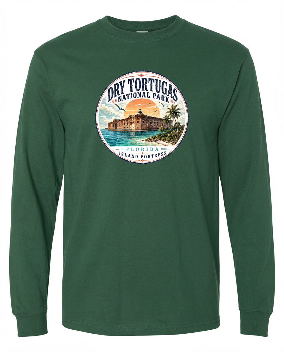 A green long-sleeved t-shirt with a circular graphic design featuring a building, palm trees, and a sunset over a body of water, representing Dry Tortugas National Park in Florida.