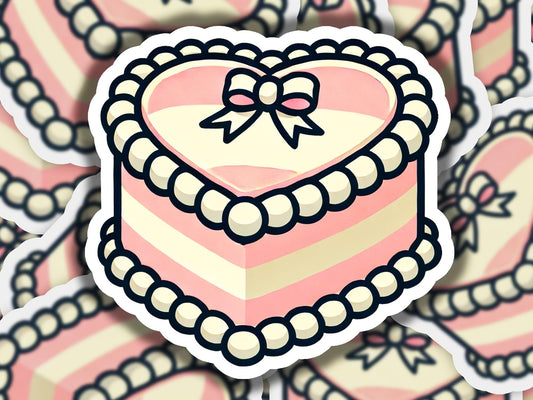 a heart shaped cake with a bow on top of it
