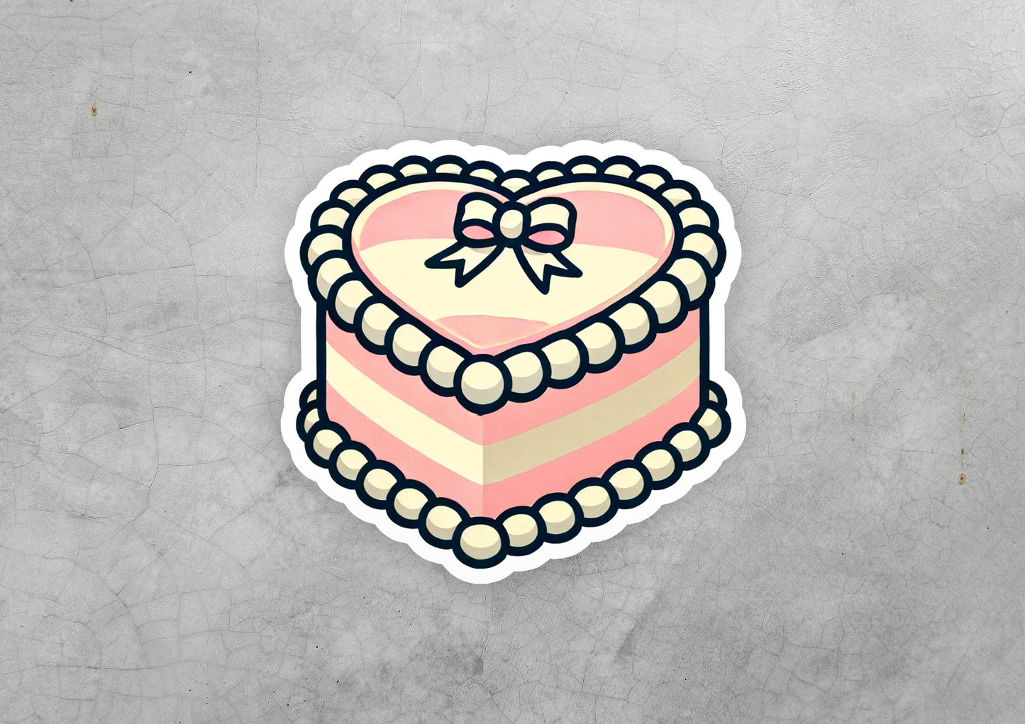 a heart shaped cake with a bow on top of it