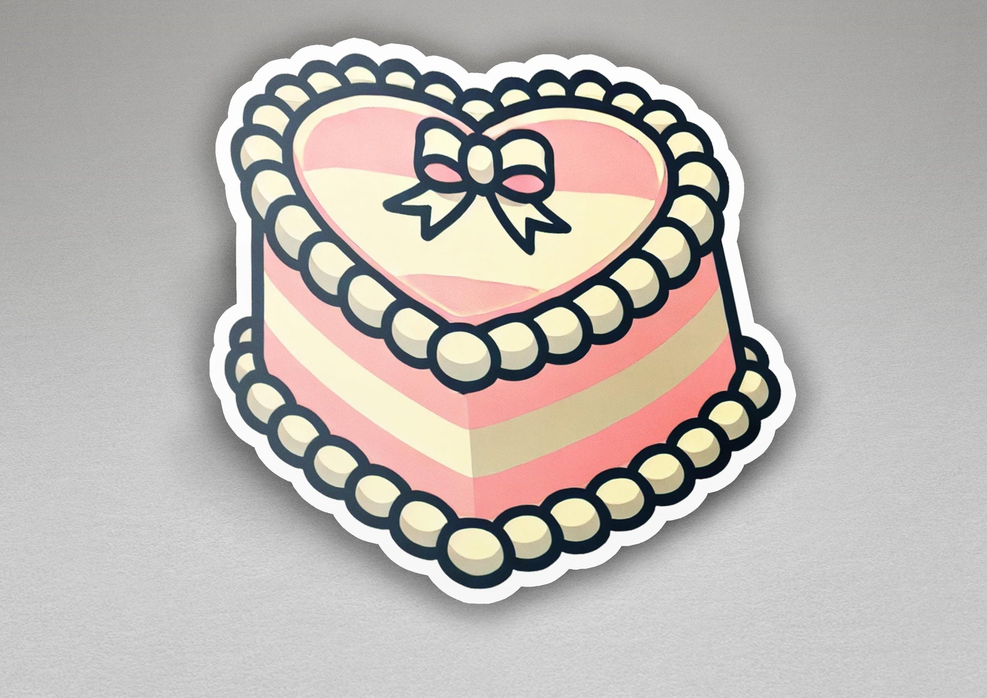 a heart shaped cake with a bow on top of it