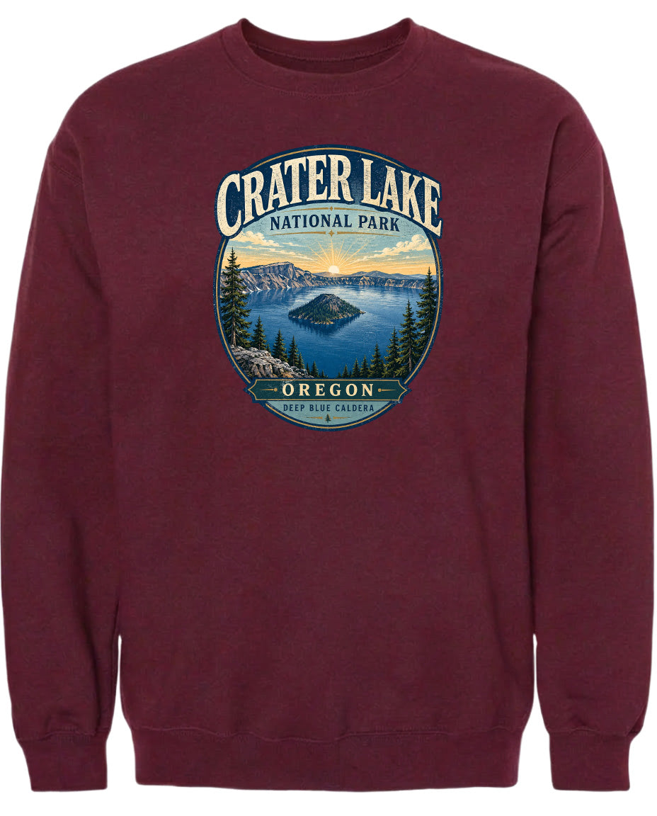 A maroon sweatshirt with a graphic design depicting Crater Lake National Park in Oregon.