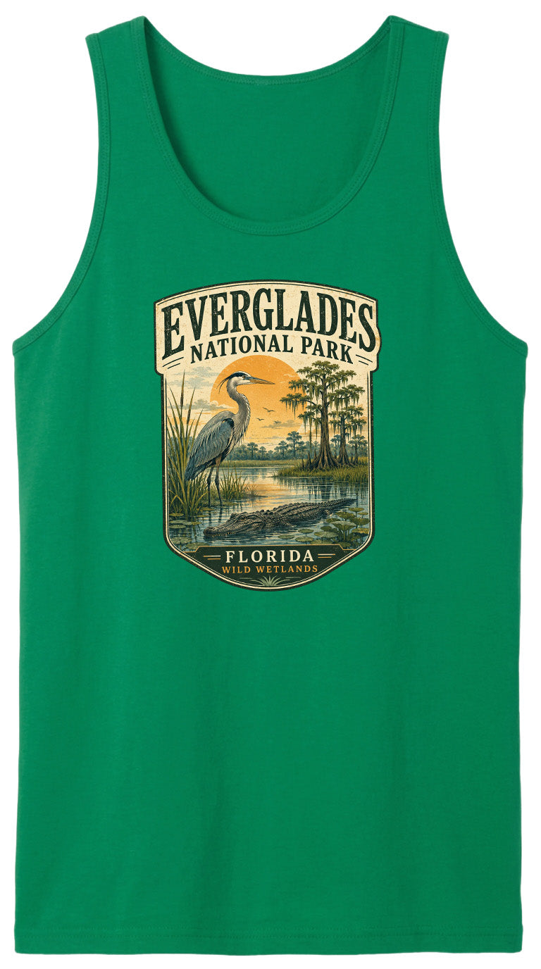 A green tank top with a graphic design depicting a bird standing in a marshy area with trees and a sunset in the background.