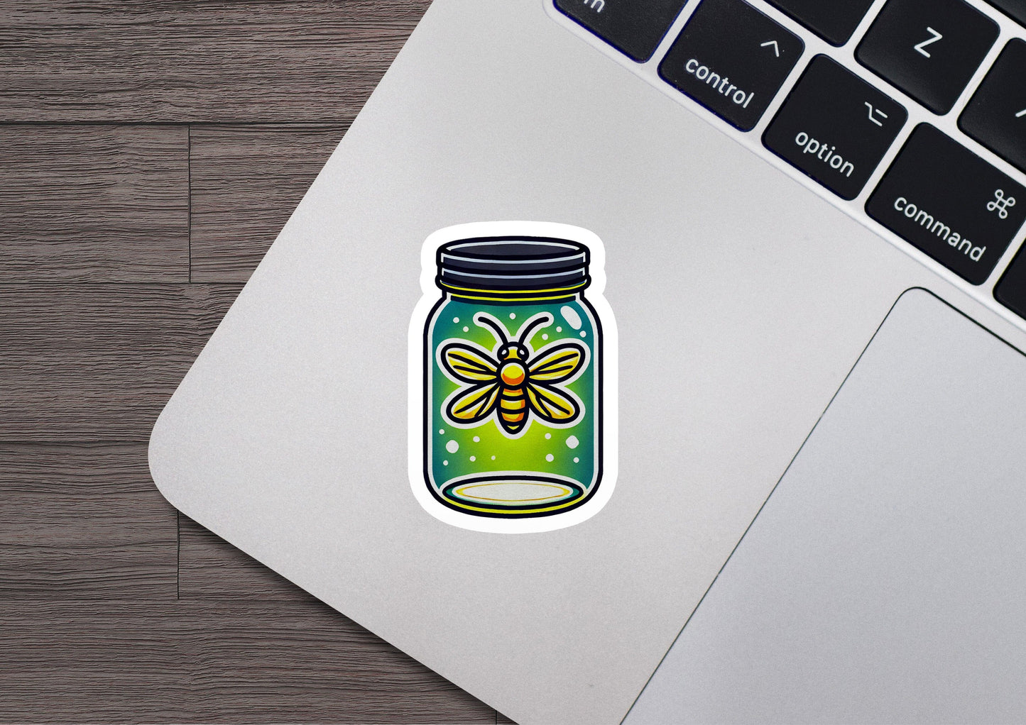 a laptop with a sticker of a jar of bees