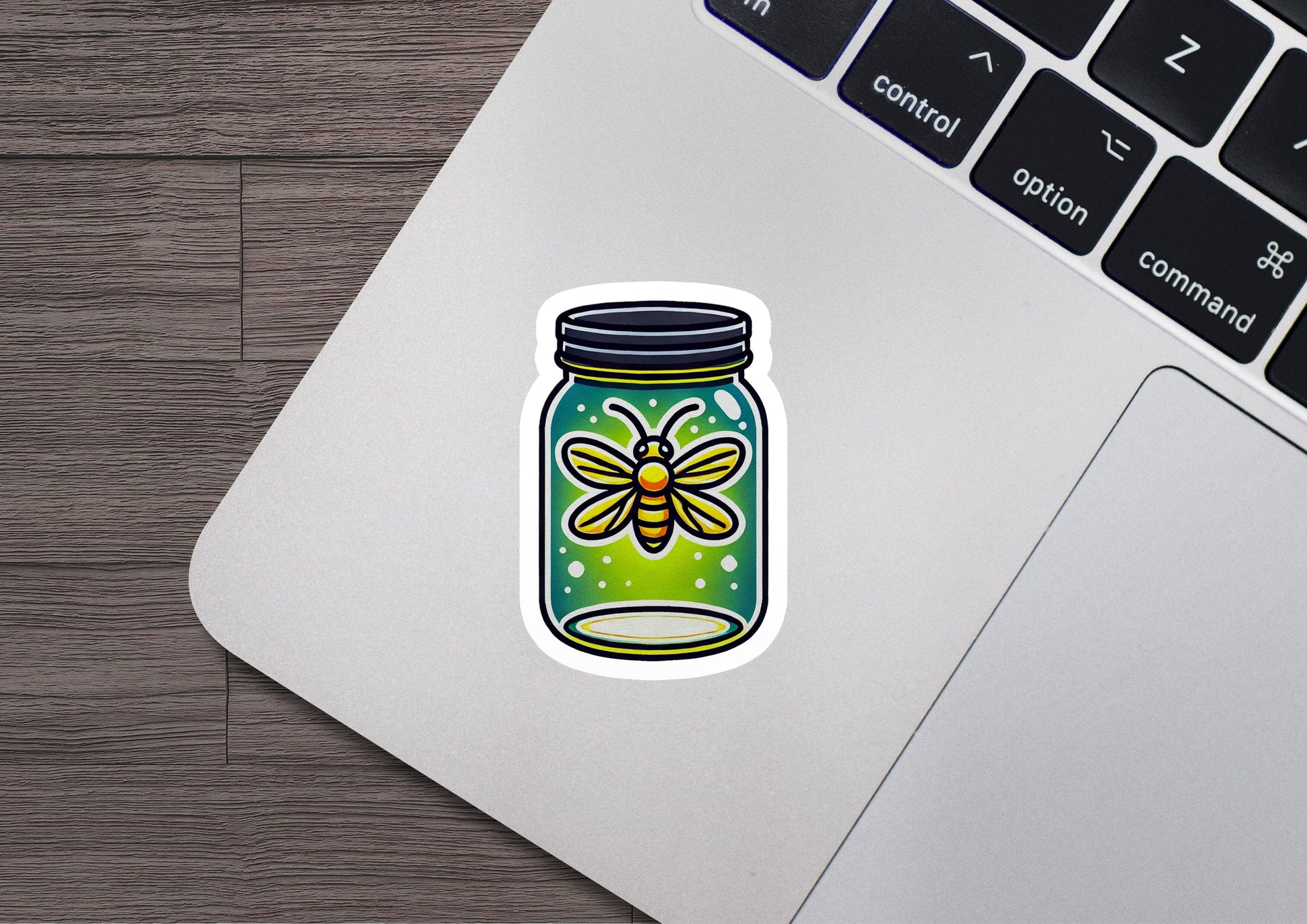 a laptop with a sticker of a jar of bees