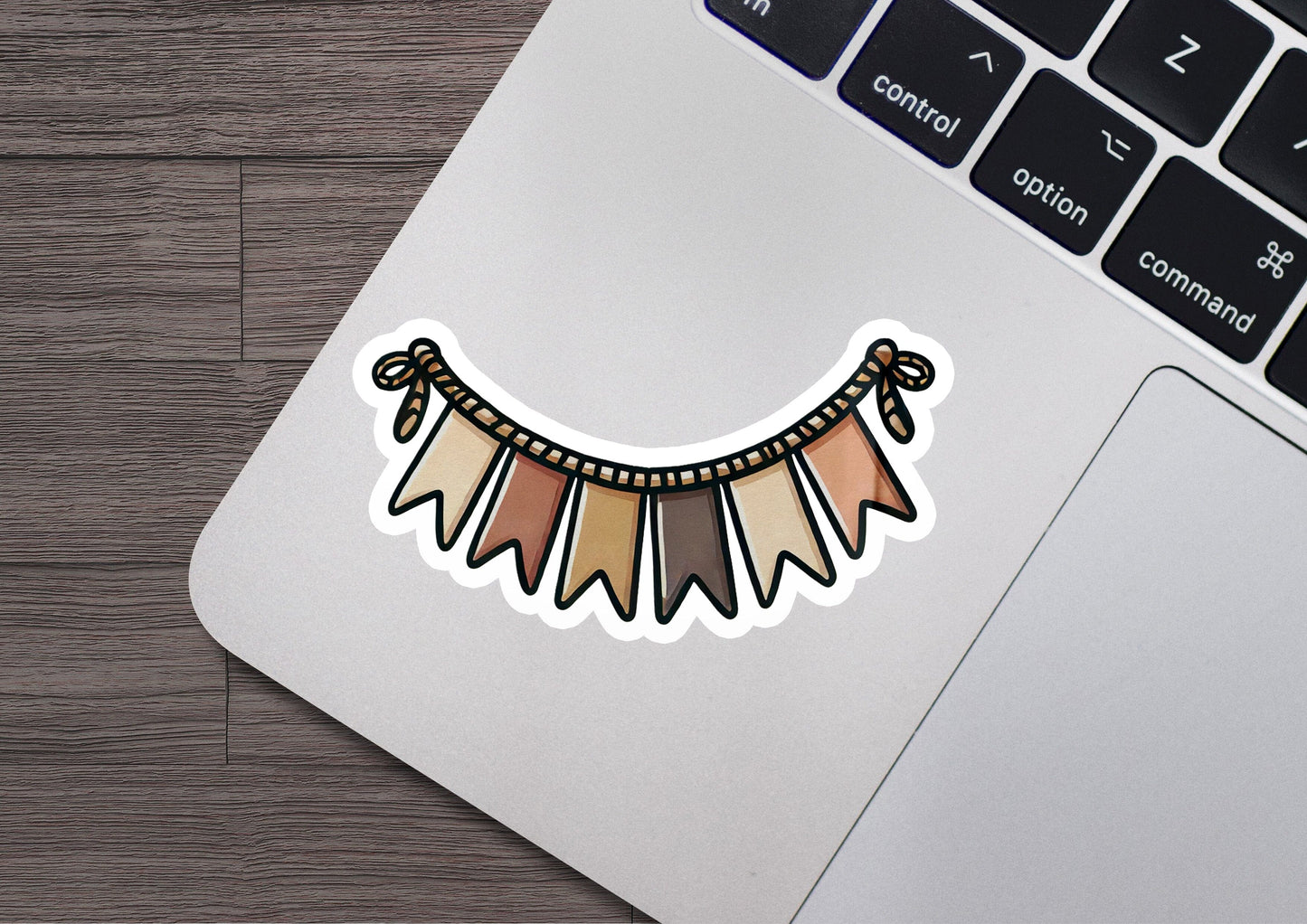 a laptop computer with a sticker of a tribal design