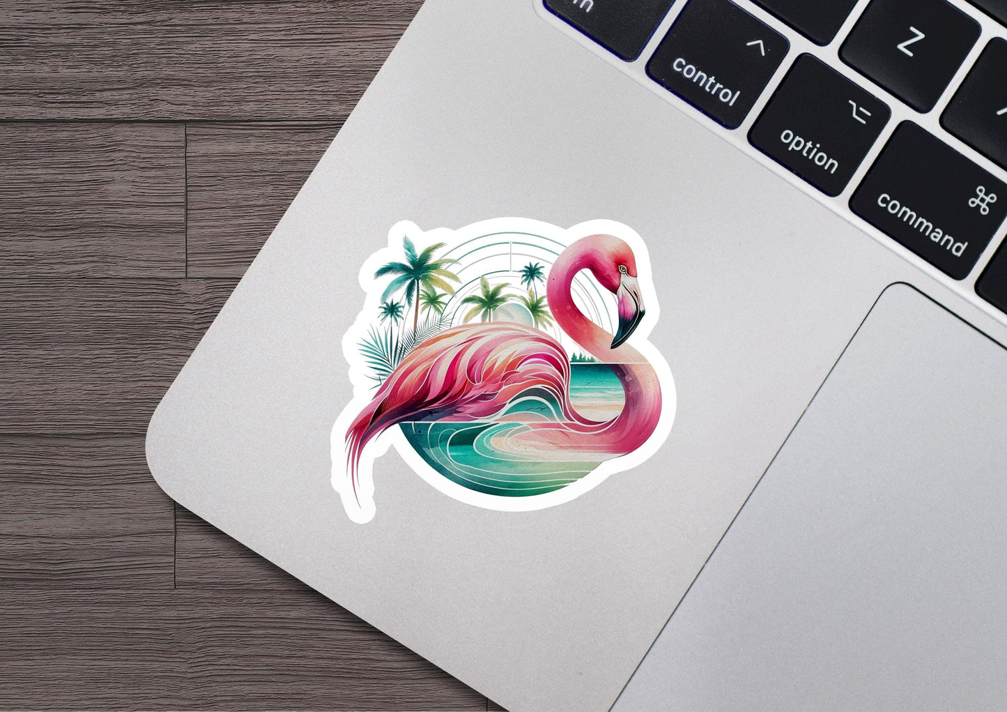 a sticker of a pink flamingo sitting on top of a laptop