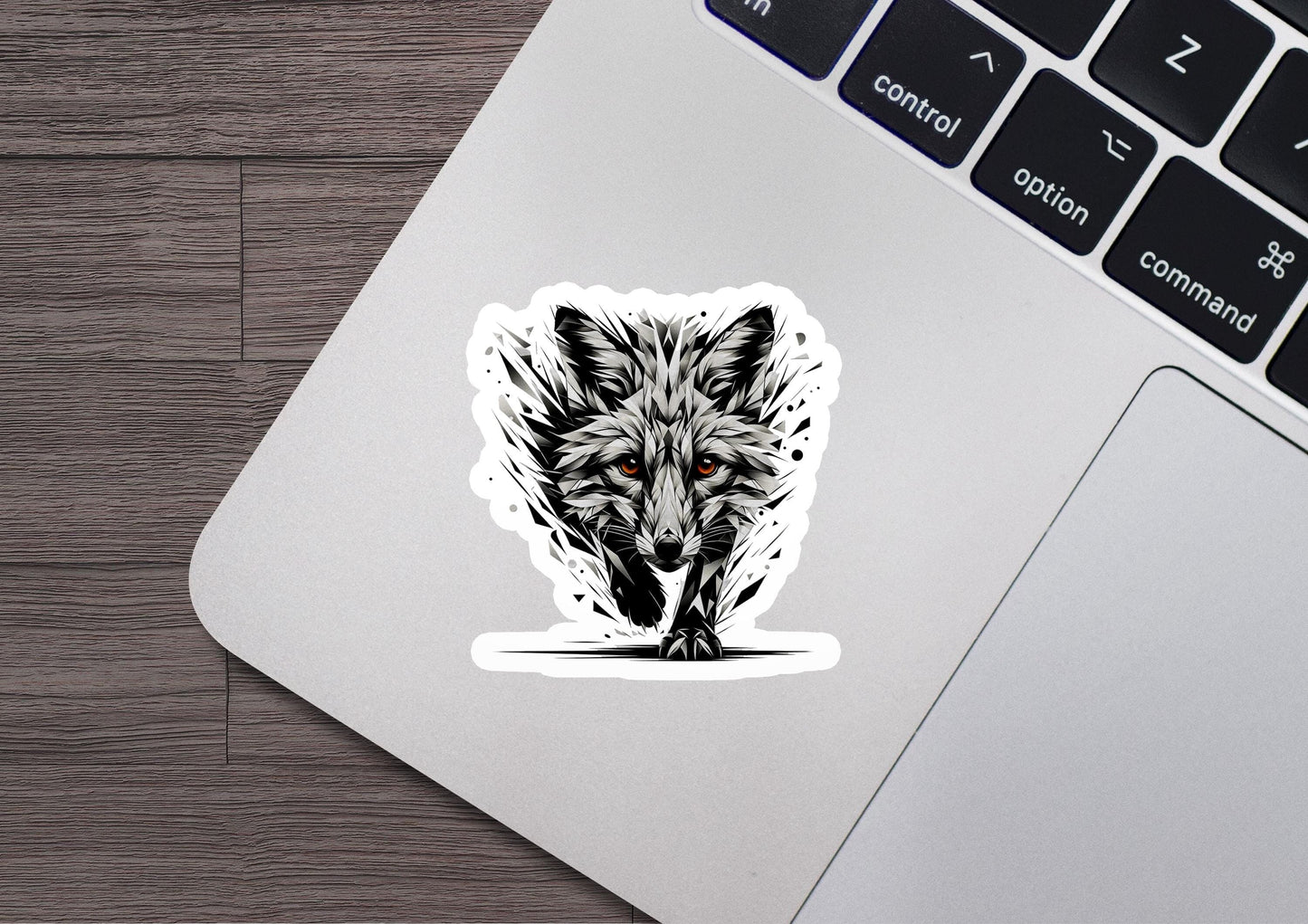 a laptop with a sticker of a wolf on it