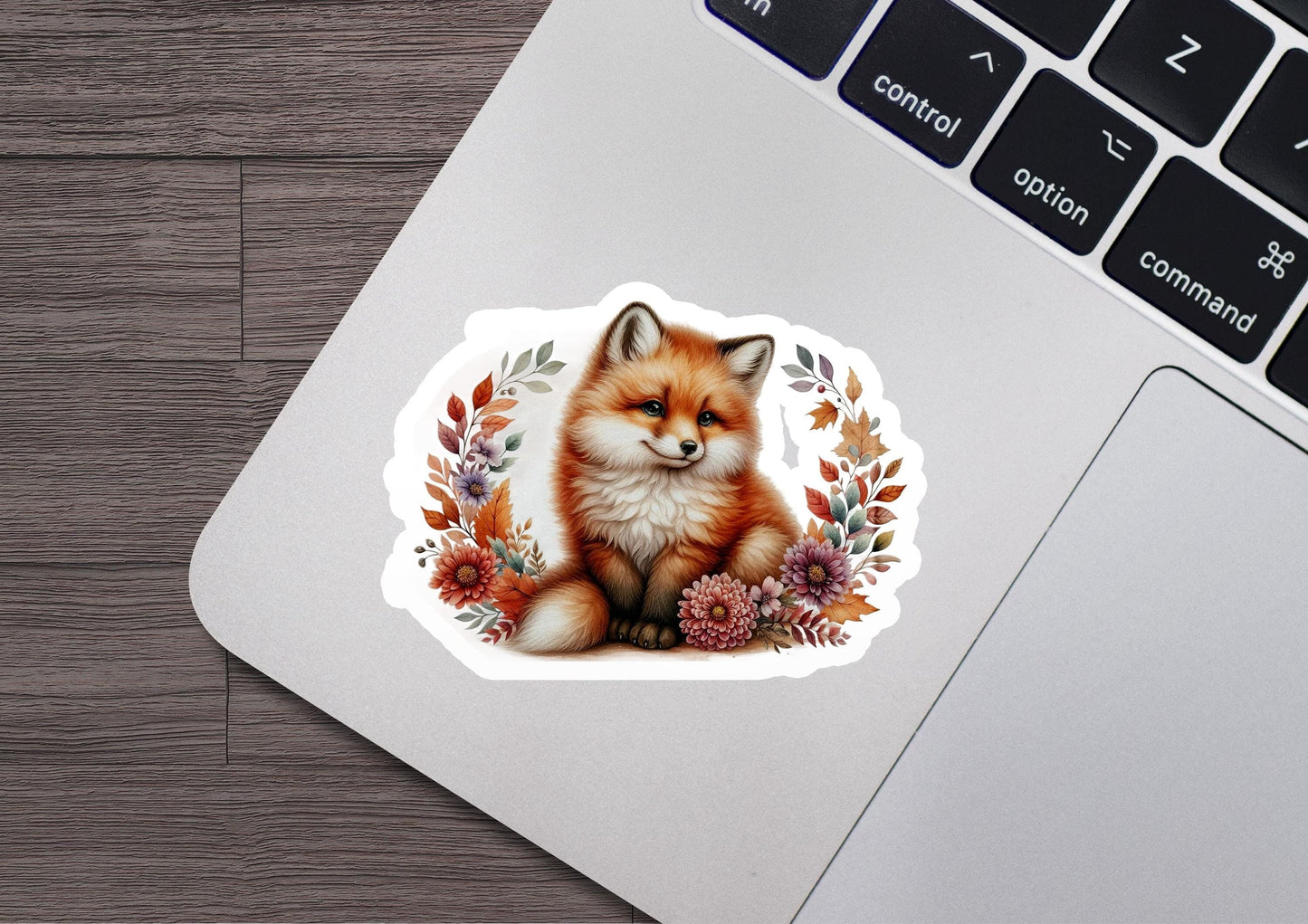 a sticker of a fox sitting on top of a laptop