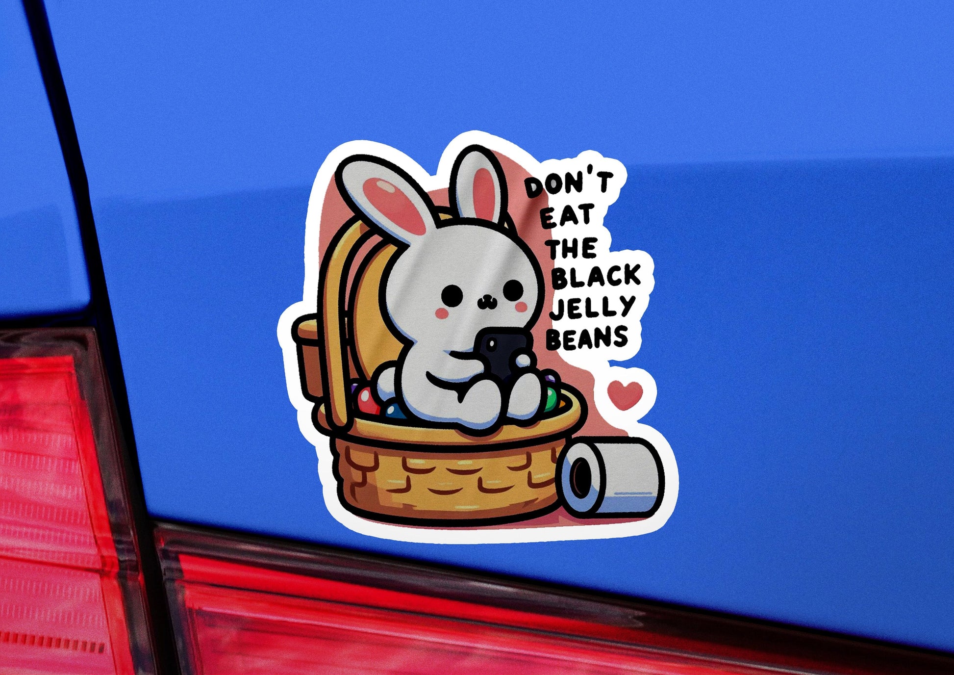 a sticker of a rabbit in a basket on the back of a car