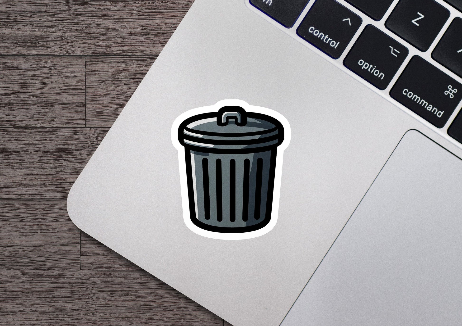 a laptop with a sticker of a trash can