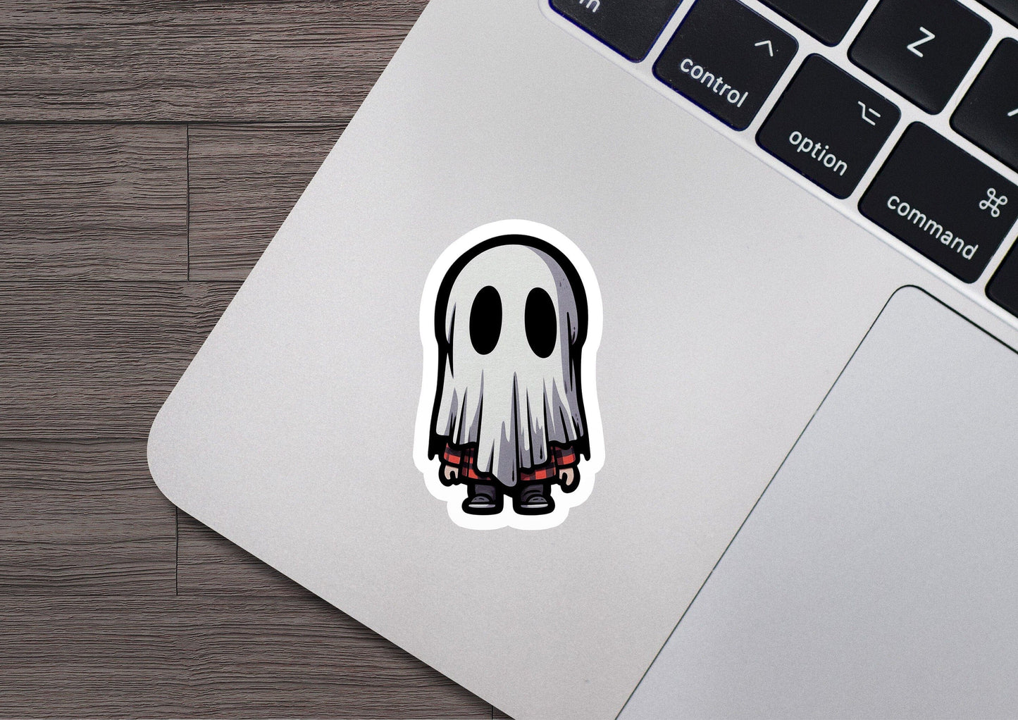 a laptop with a sticker of a ghost