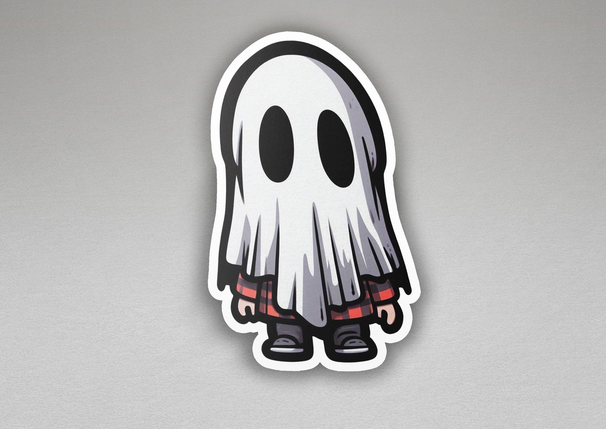 a sticker of a ghost with red eyes