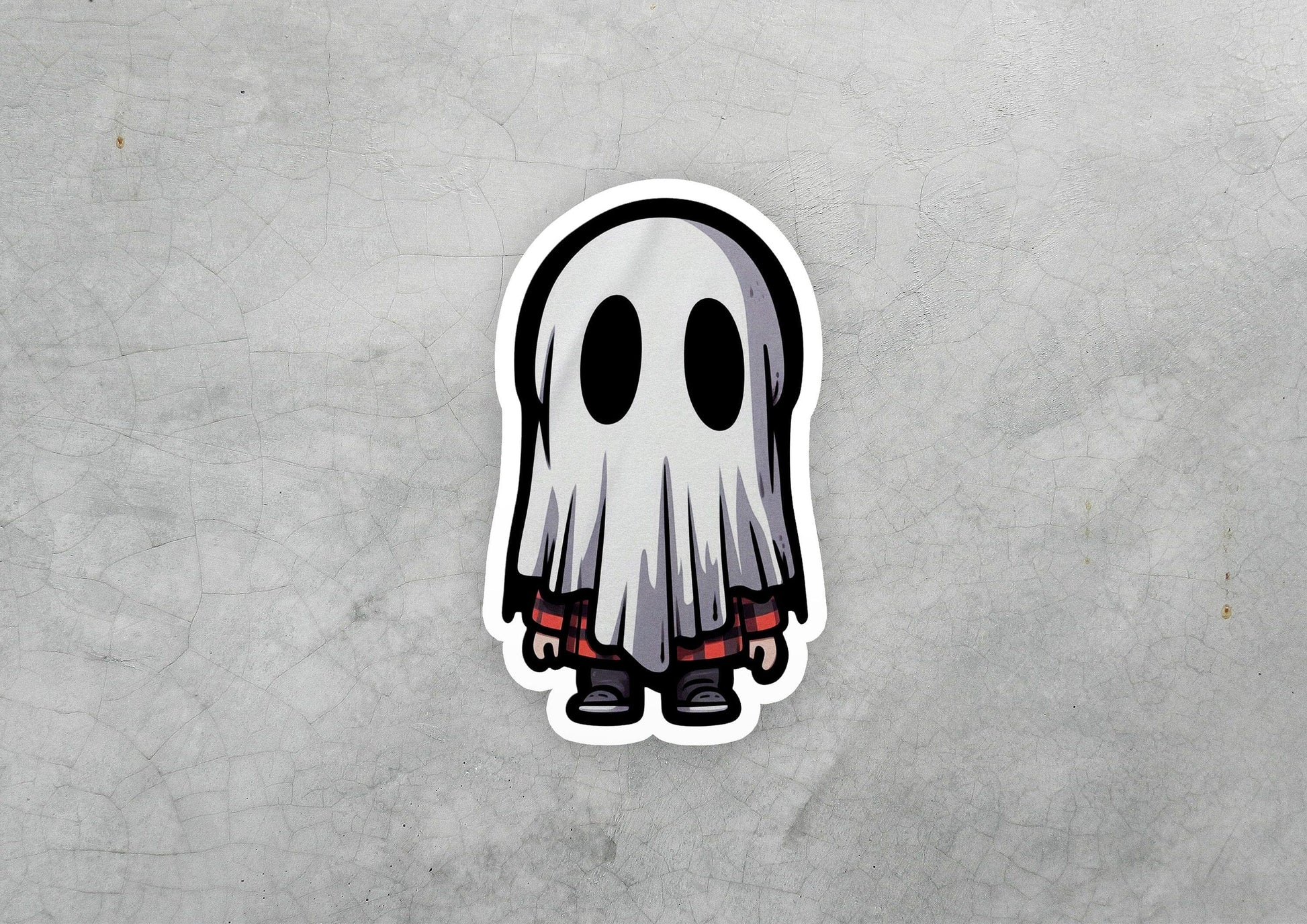 a sticker of a ghost with red eyes