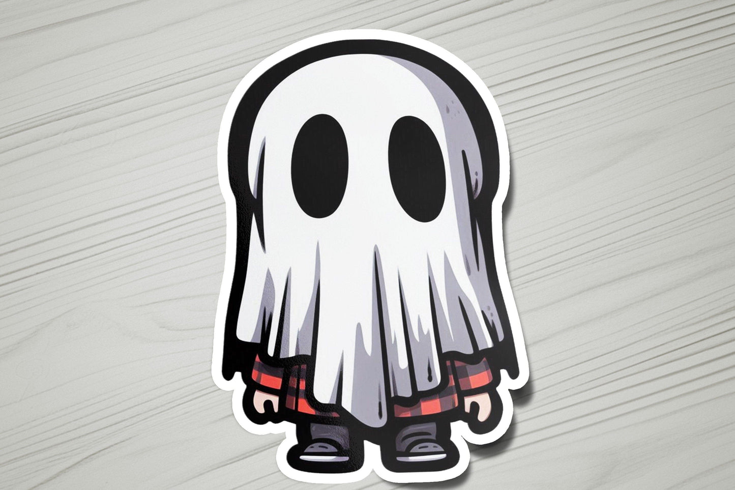 a sticker of a ghost on a wooden surface