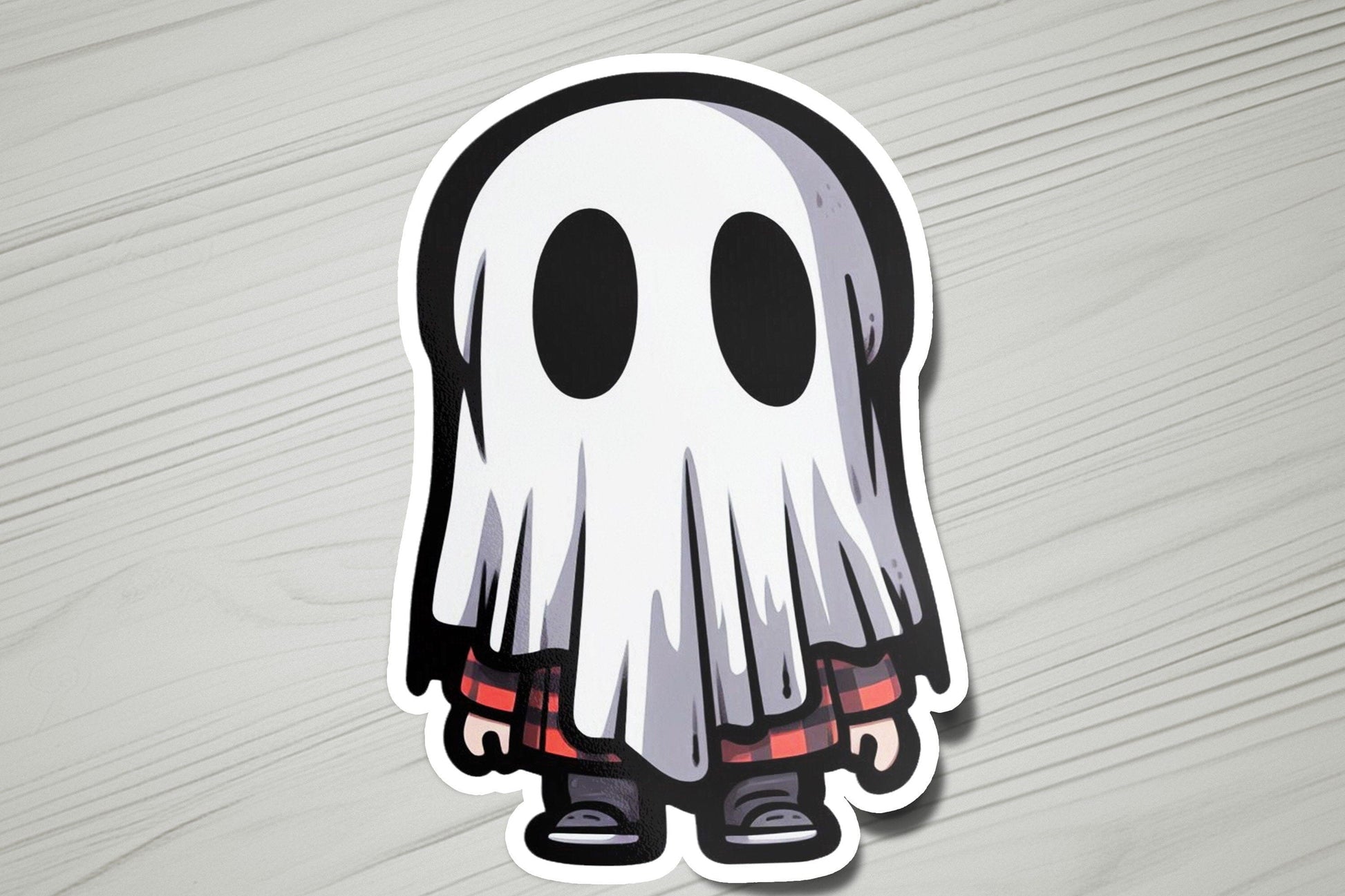 a sticker of a ghost on a wooden surface