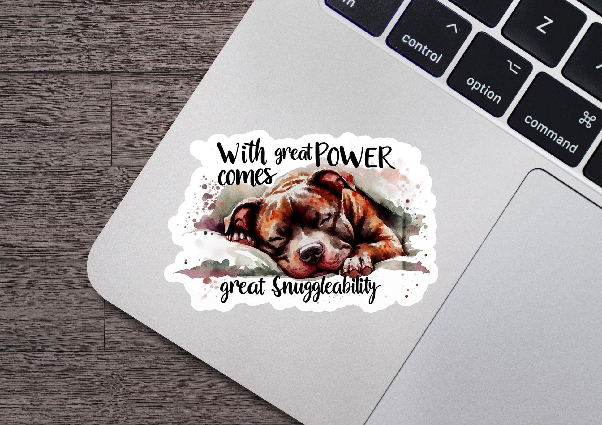 a sticker of a dog sleeping on a laptop keyboard