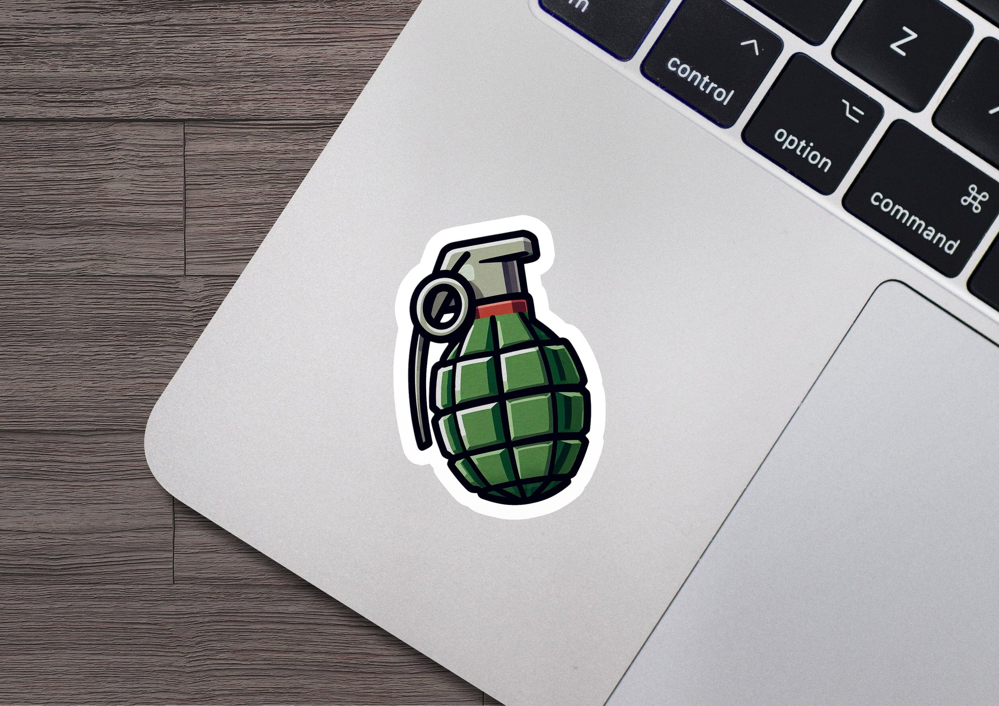 a laptop computer with a sticker of a green bomb