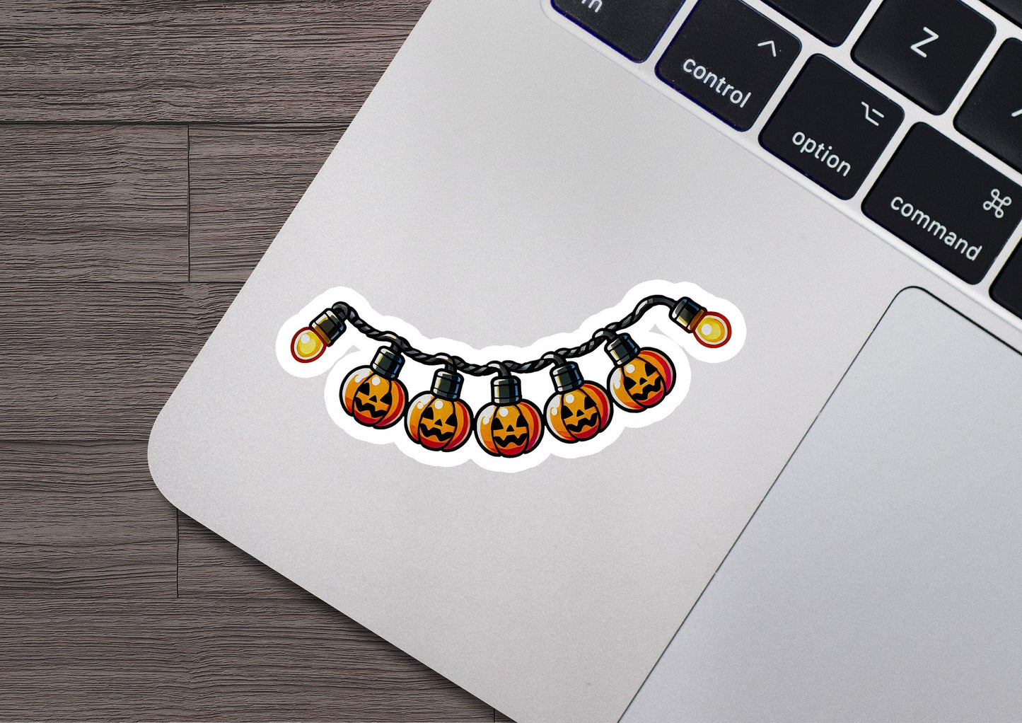 a laptop with a sticker of a string of lights on it