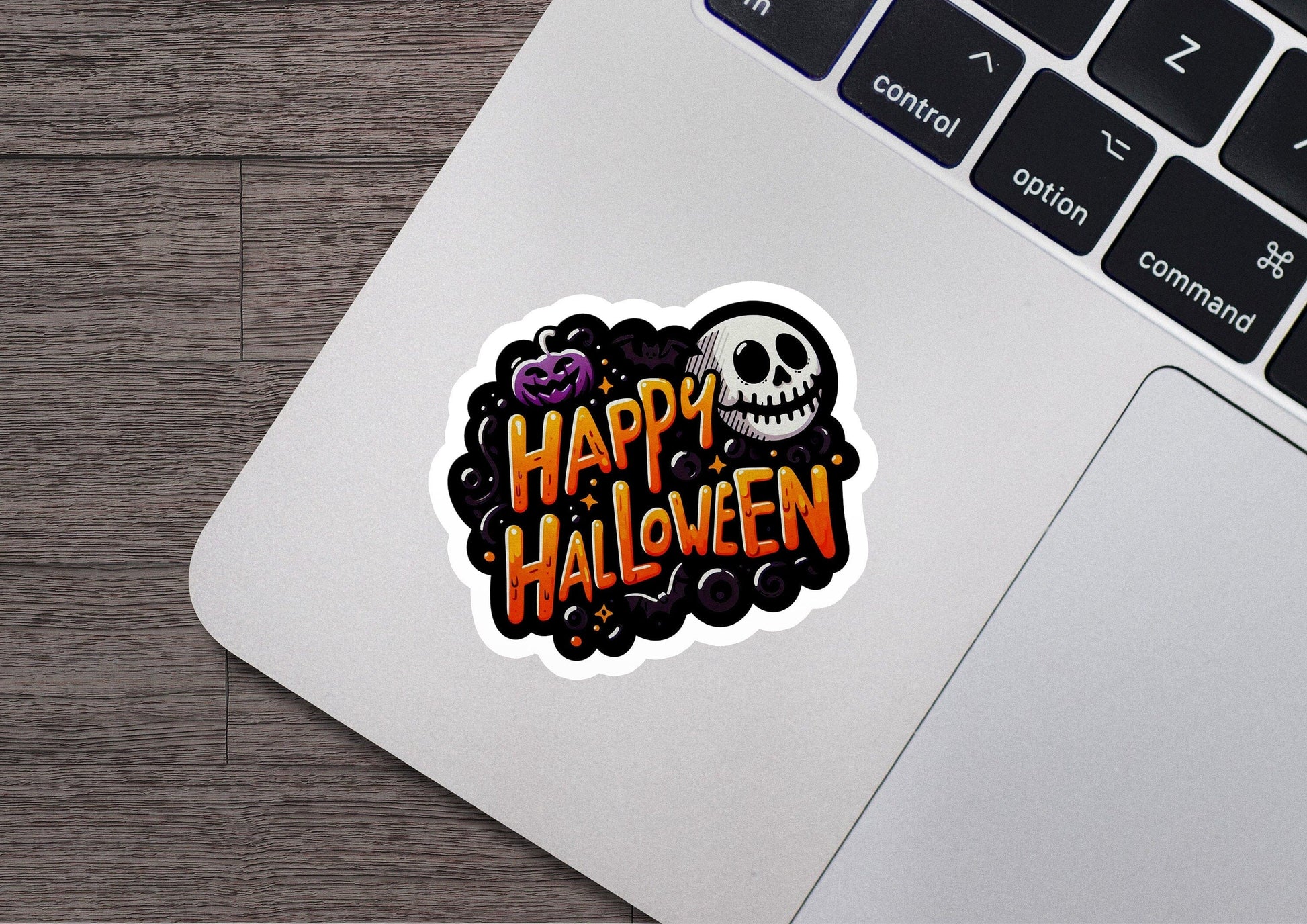 a laptop computer with a sticker of a skull on it