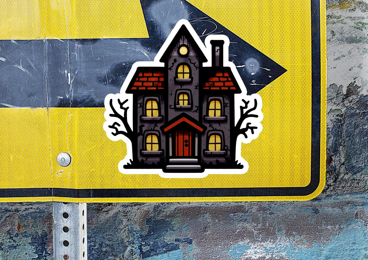a sticker of a house on a street sign