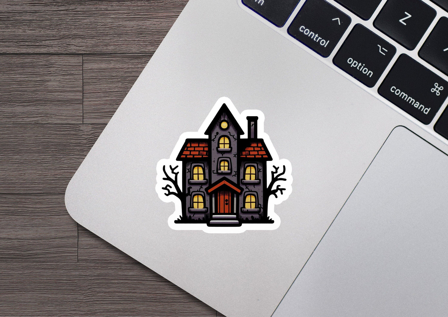 a laptop with a sticker of a house on it