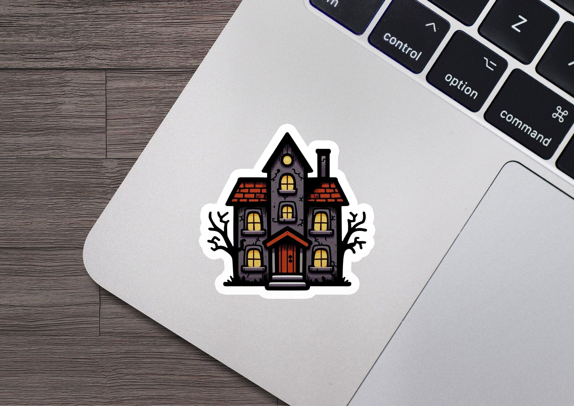 a laptop with a sticker of a house on it