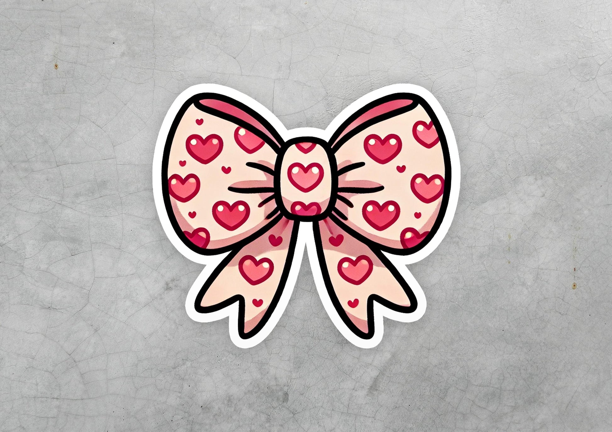 a sticker of a bow with hearts on it