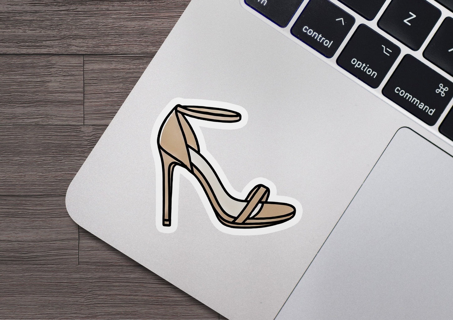 a laptop with a sticker of a high heel shoe