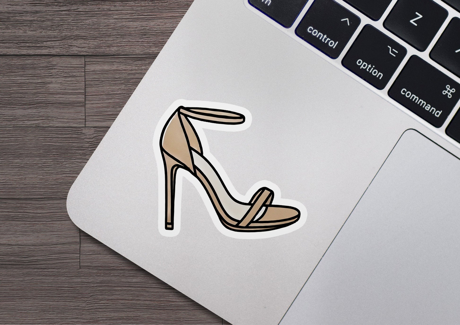 a laptop with a sticker of a high heel shoe