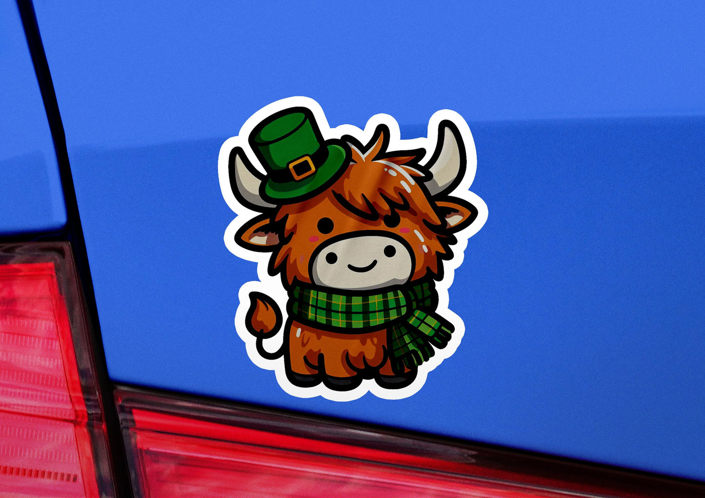 a sticker of a cow wearing a green hat and scarf