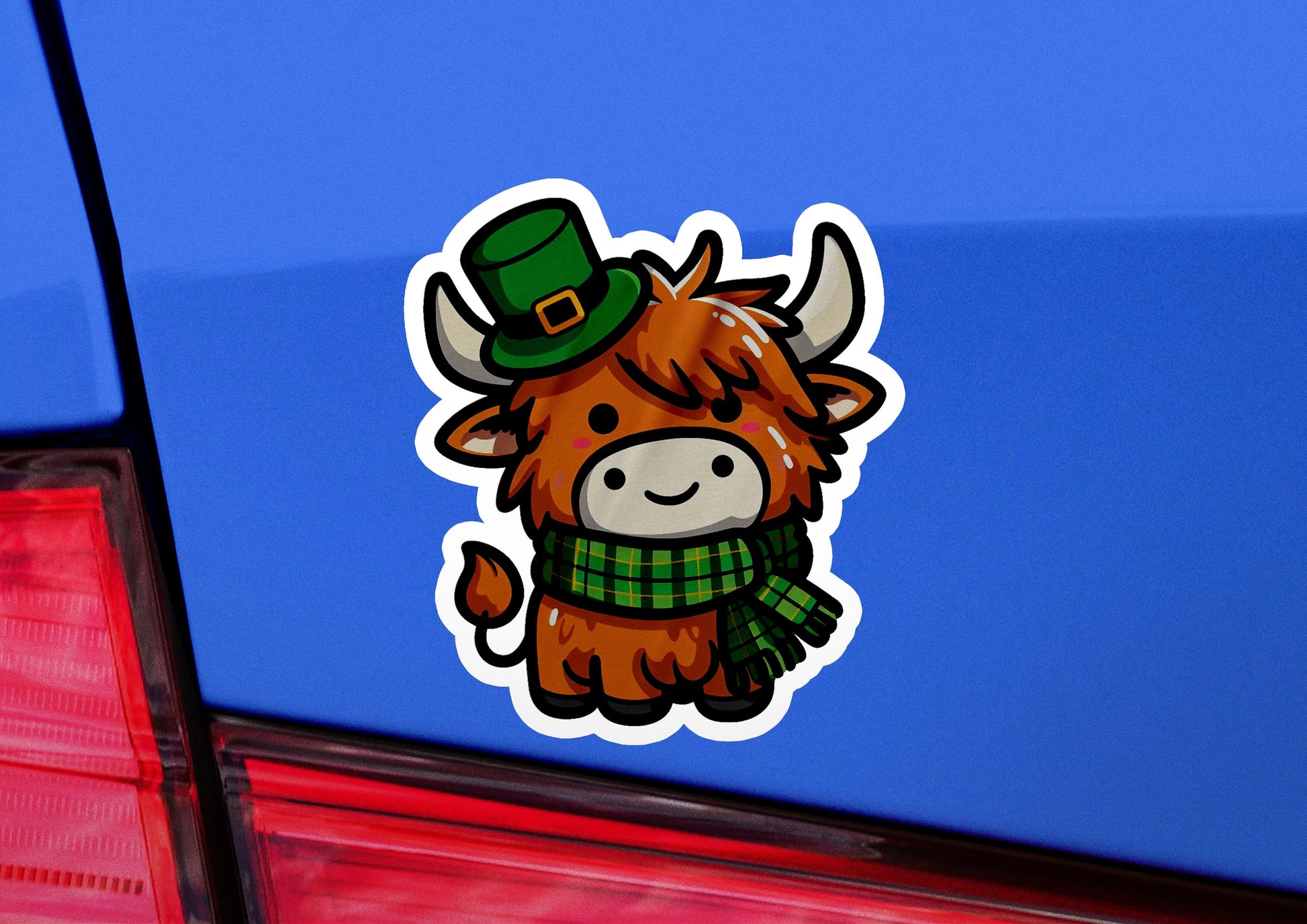 a sticker of a cow wearing a green hat and scarf