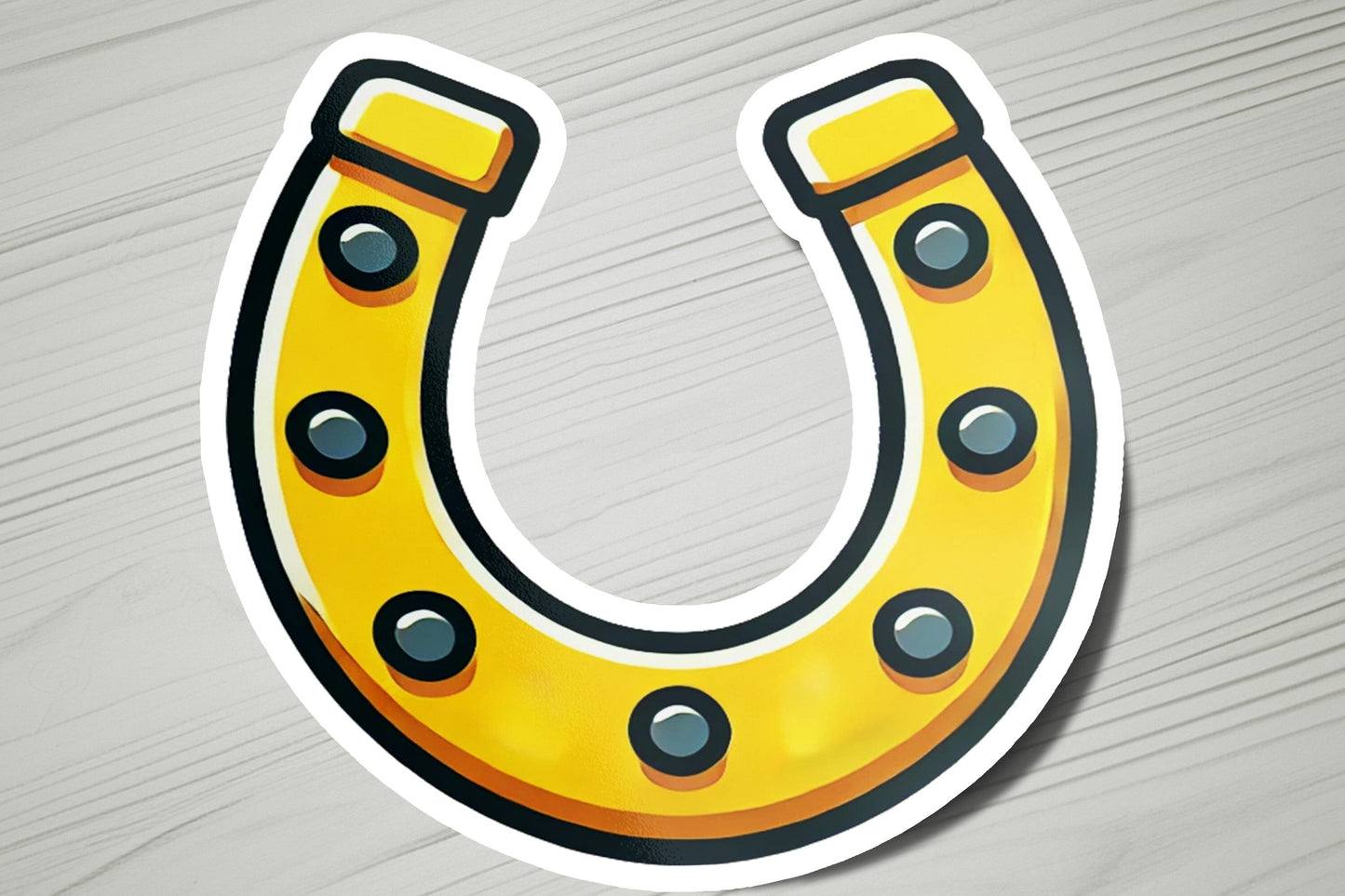 a sticker of a yellow horseshoe on a wooden surface