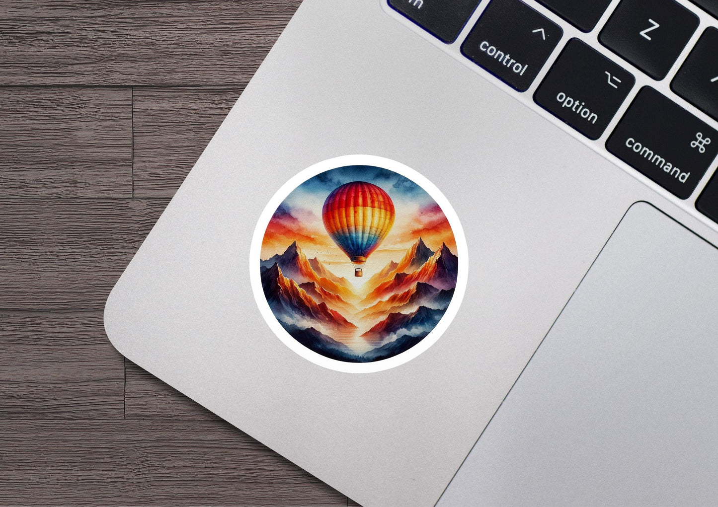 a laptop with a sticker of a hot air balloon