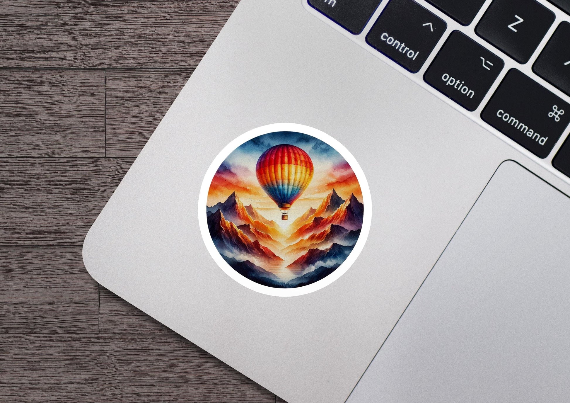 a laptop with a sticker of a hot air balloon