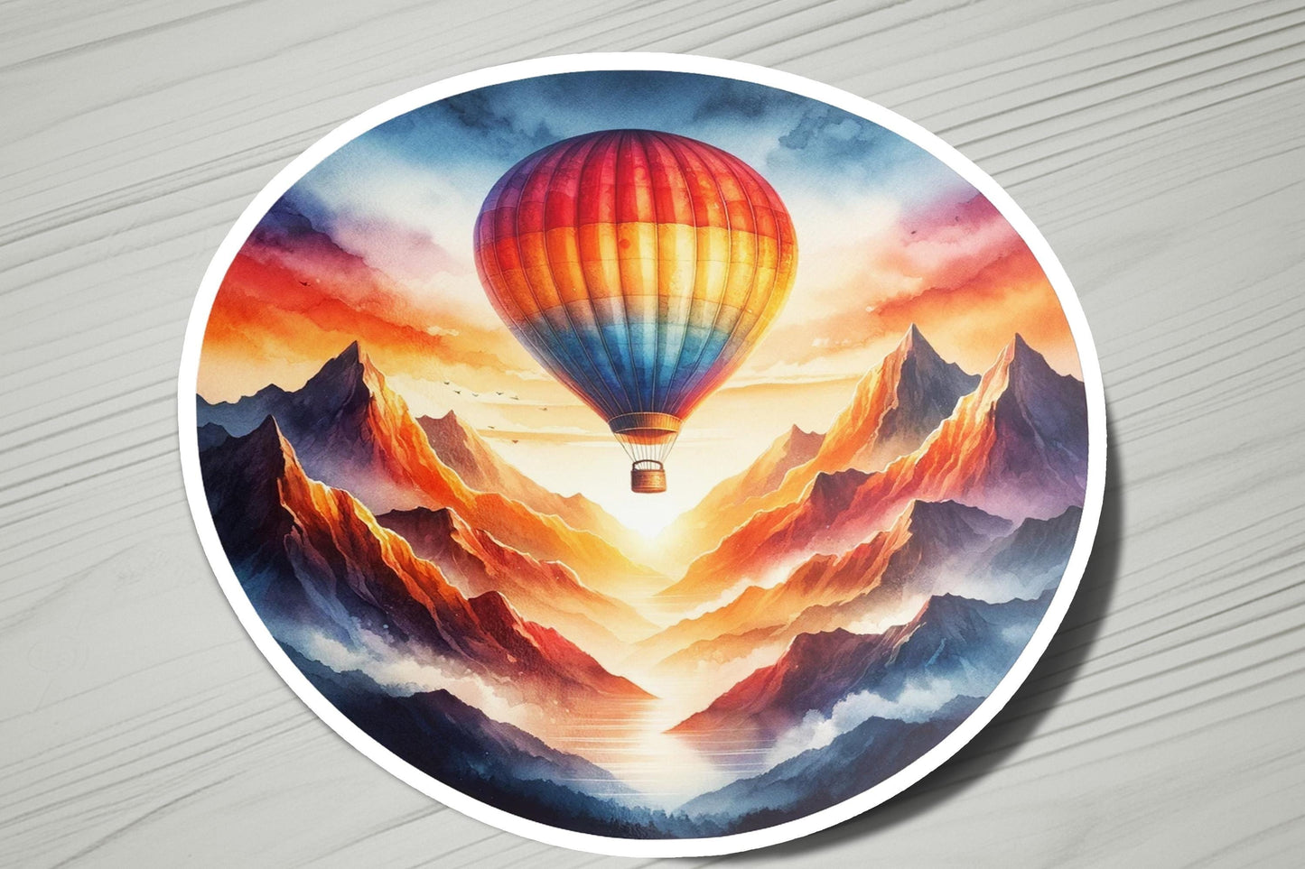 a painting of a hot air balloon flying over mountains