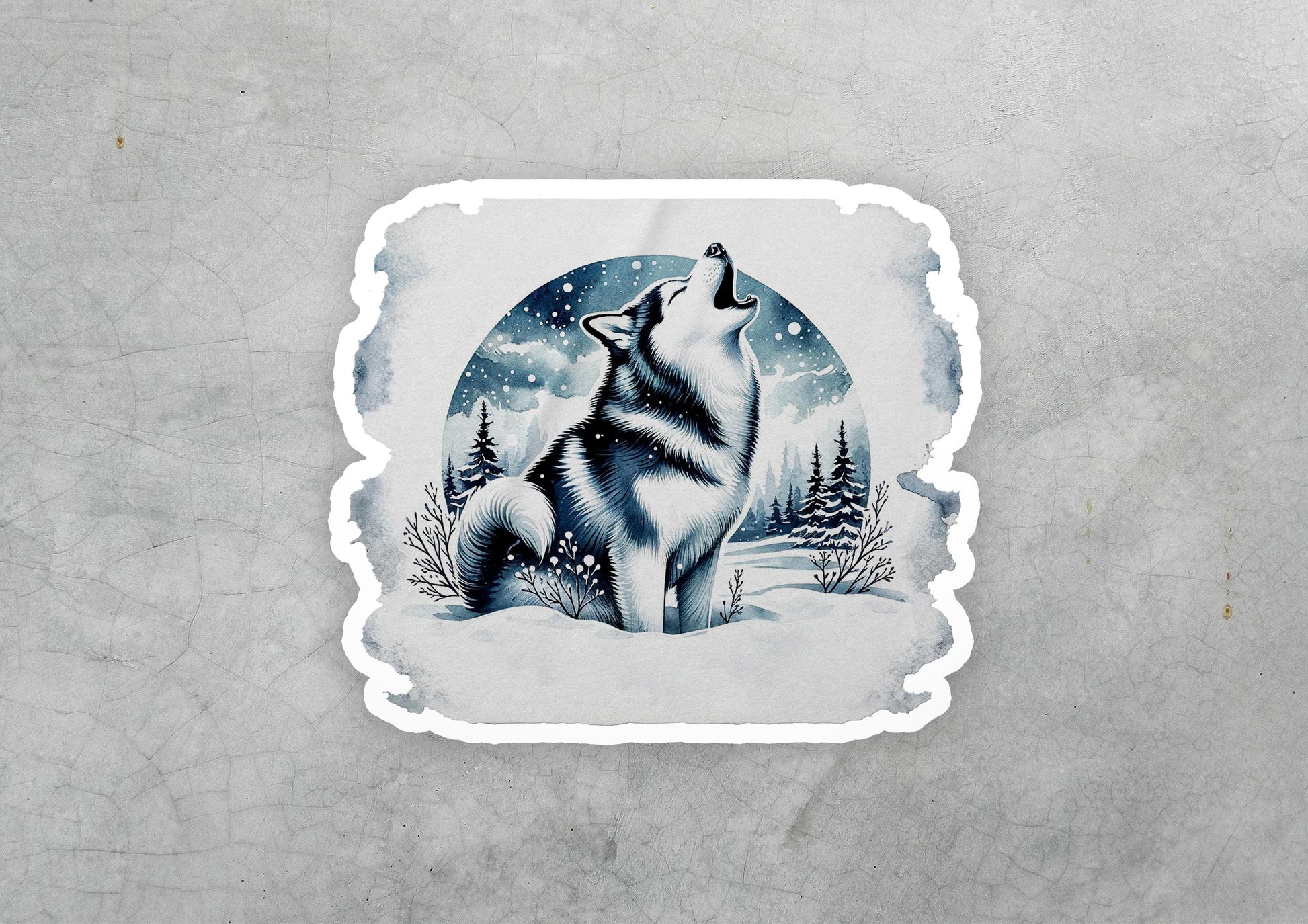 a sticker of a wolf sitting in the snow