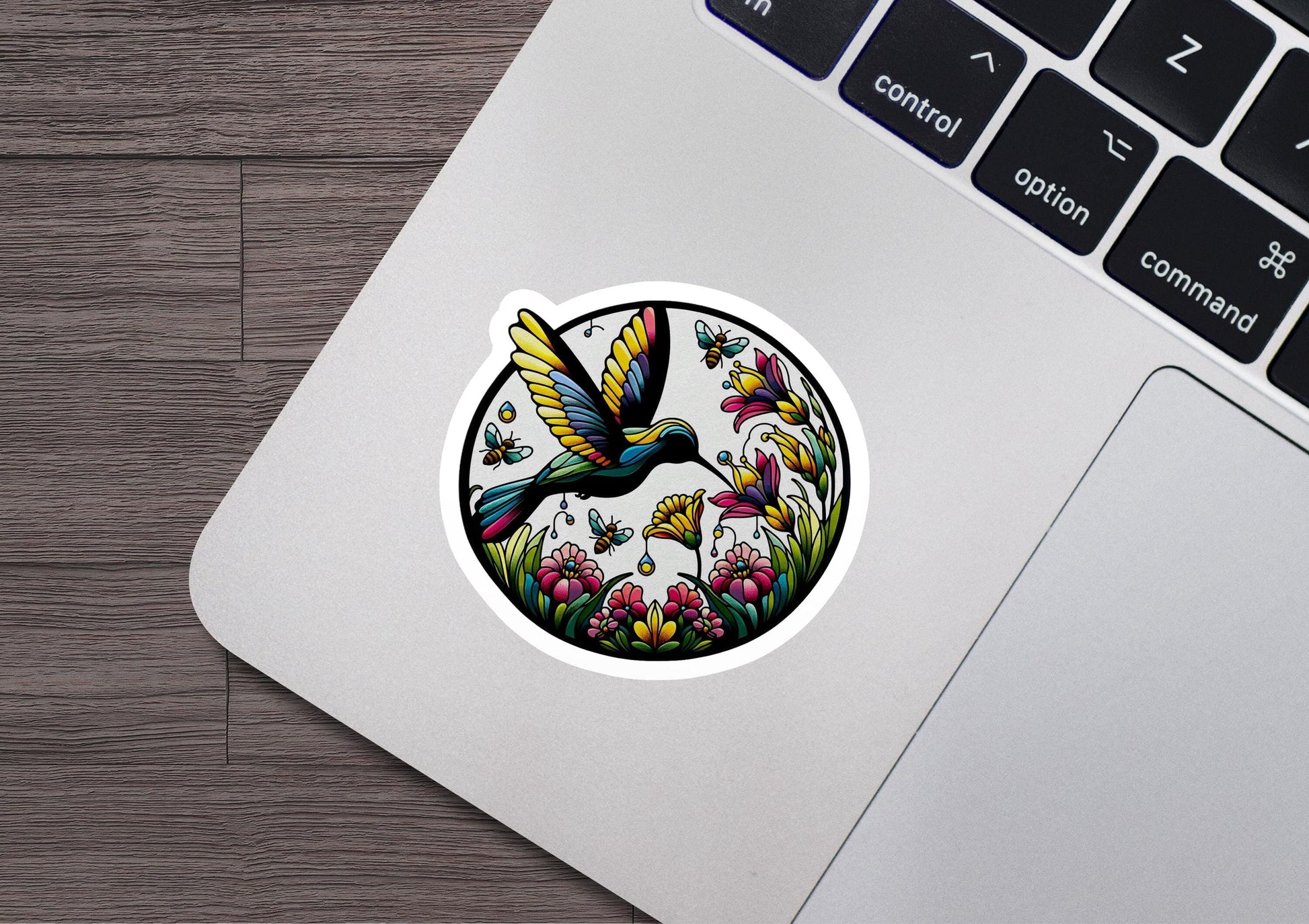 a laptop with a sticker of a humming bird