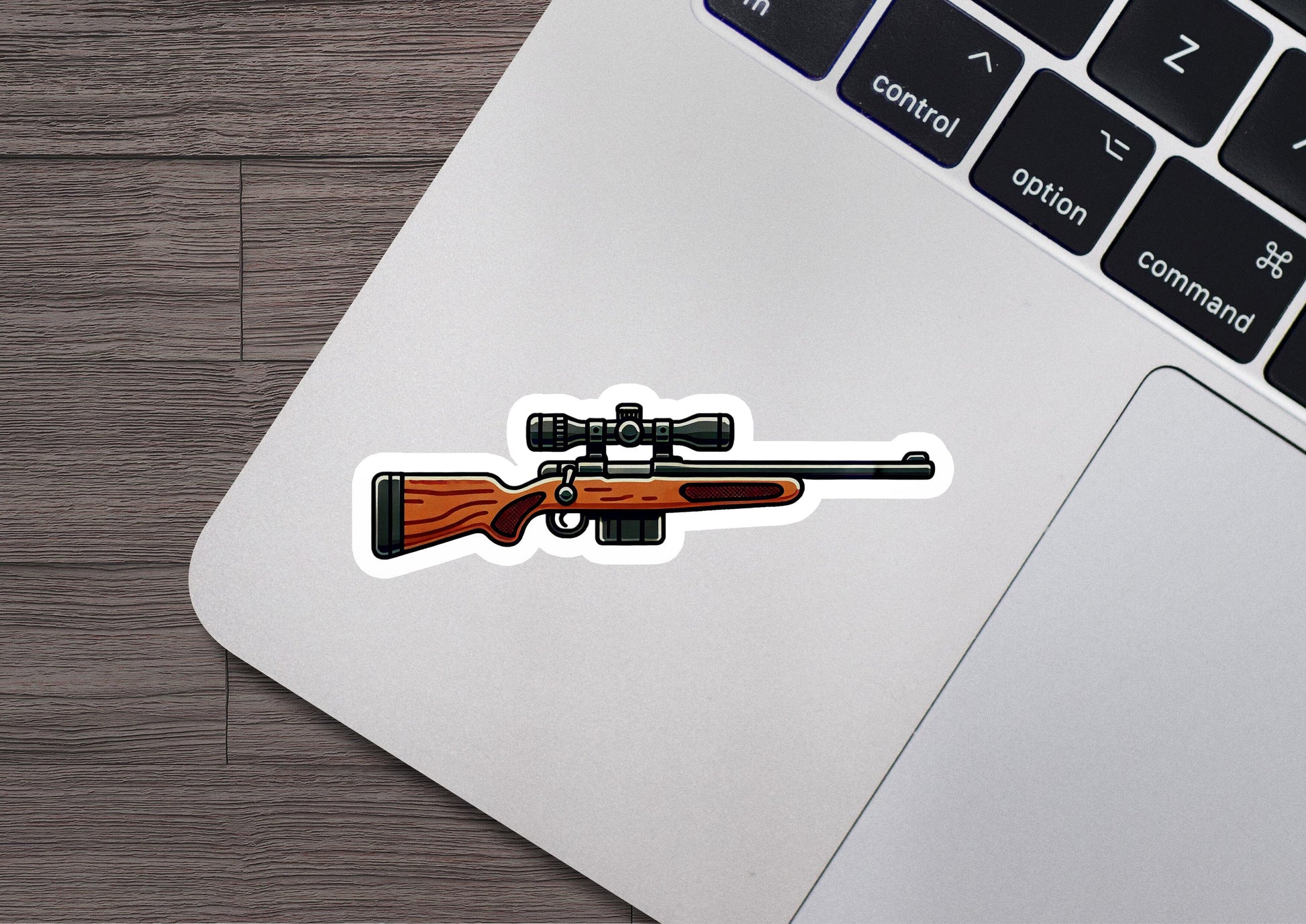 a sticker of a rifle on a laptop