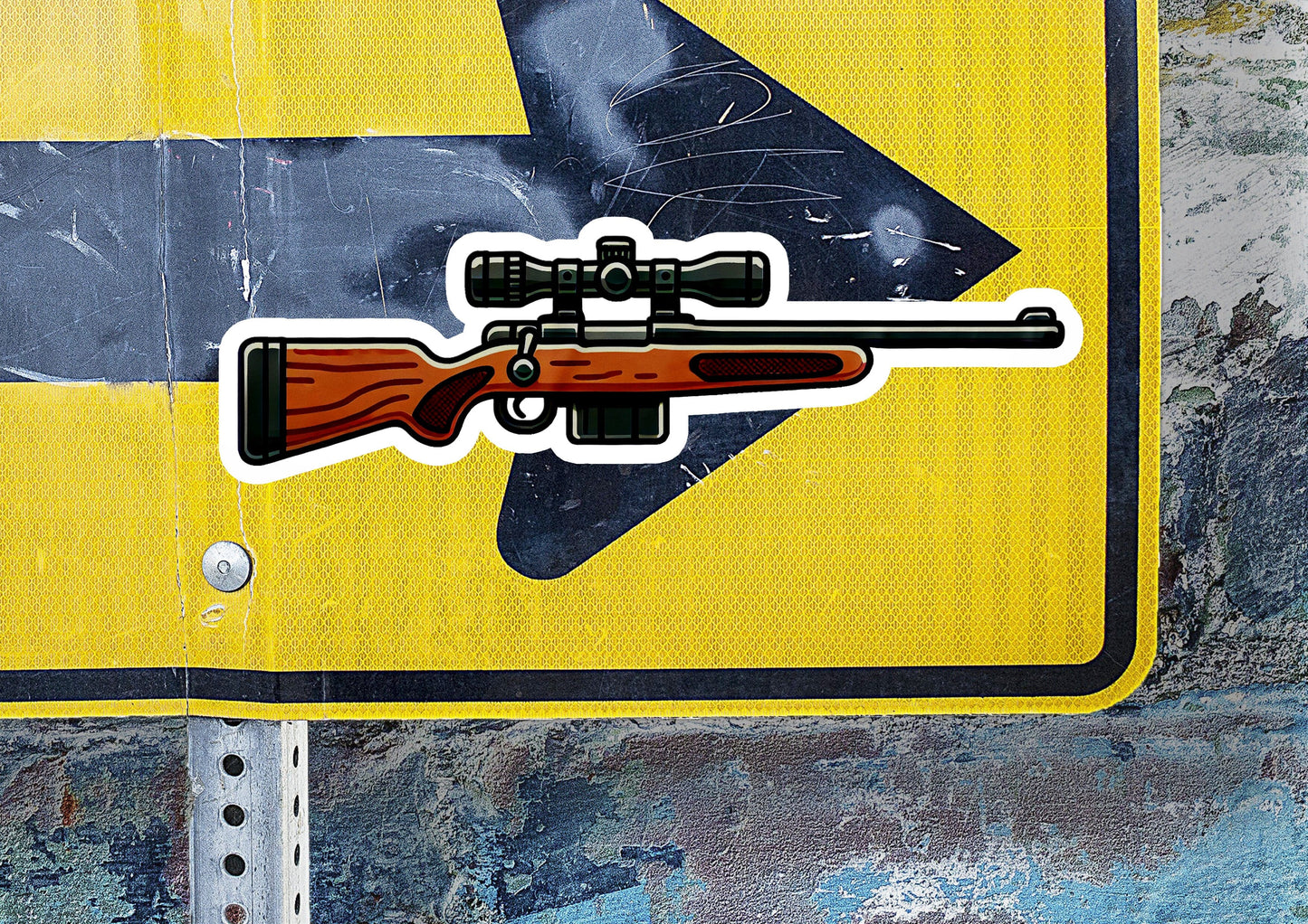 a sticker of a gun on a yellow sign