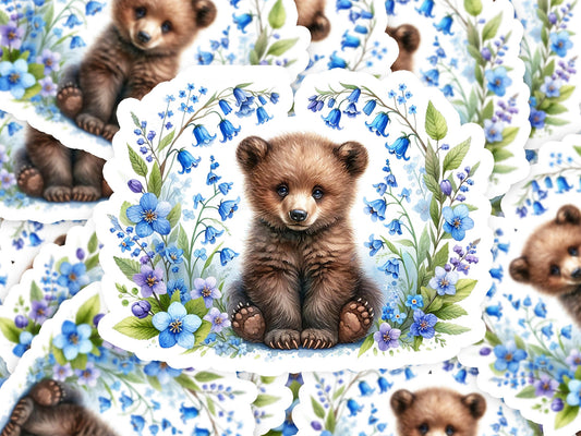 a picture of a brown bear surrounded by blue flowers