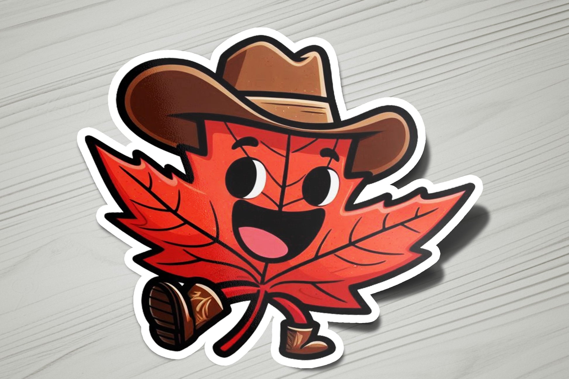 a sticker of a maple leaf wearing a cowboy hat