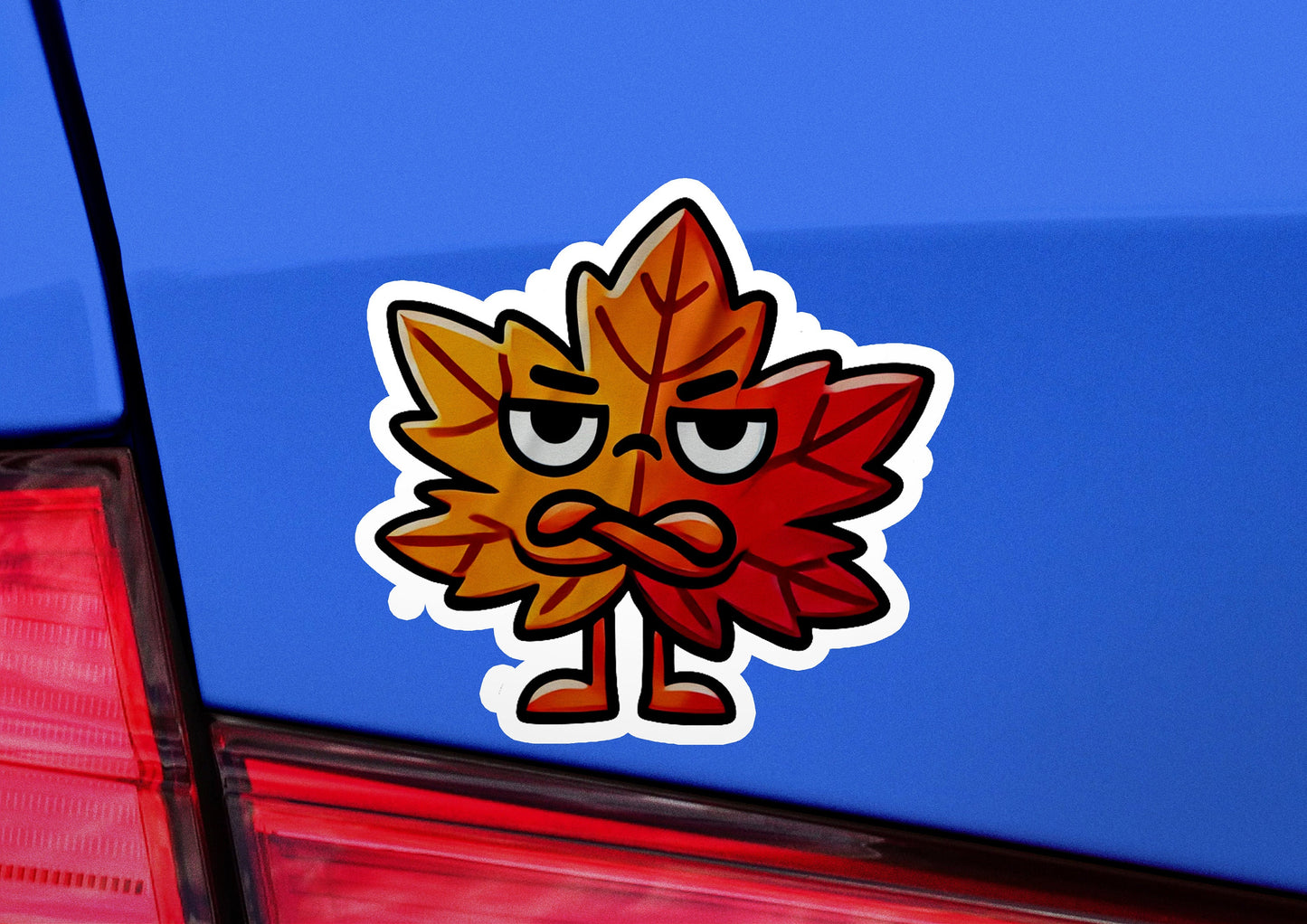 a sticker of a leaf with a frowning face