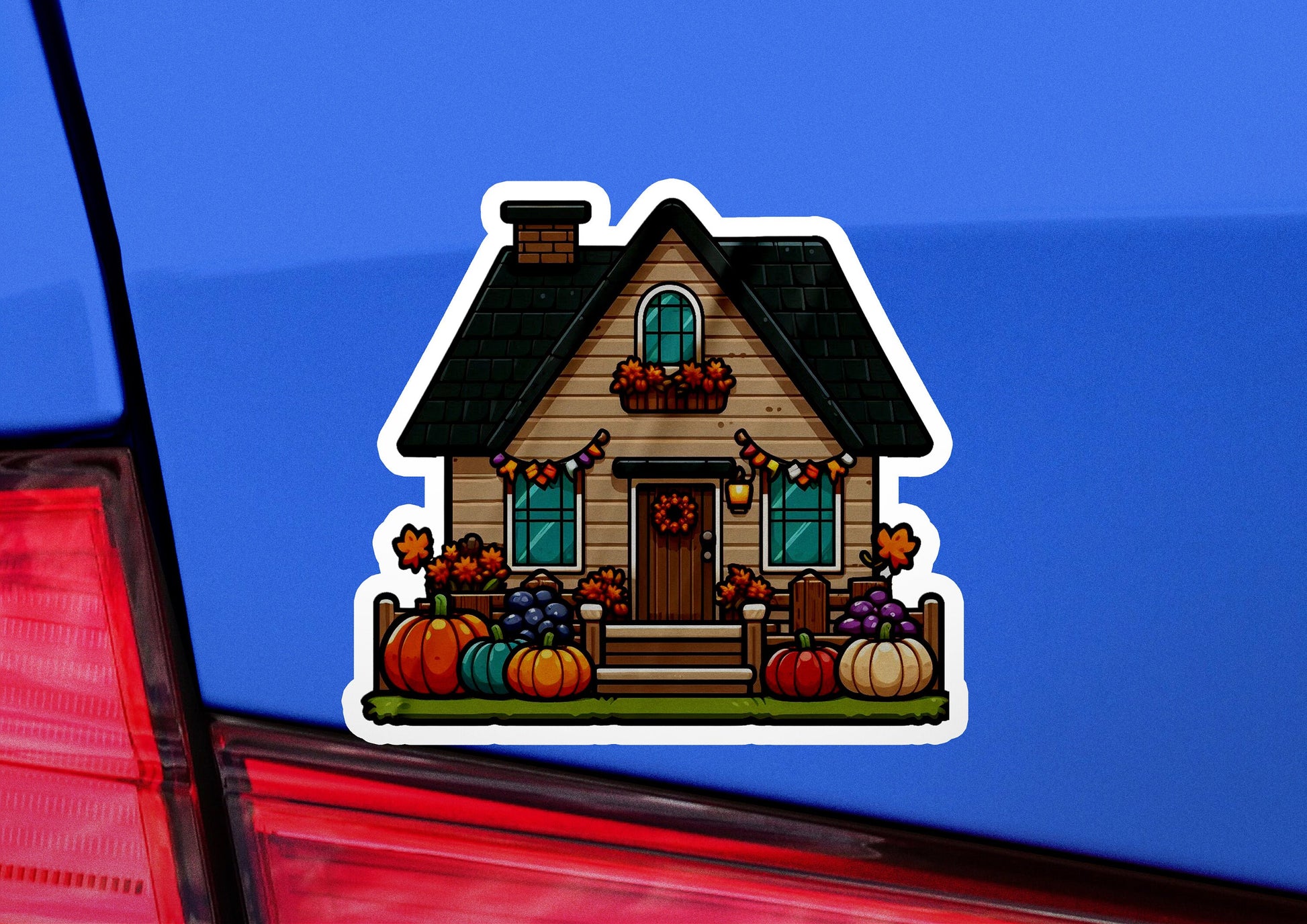 a car with a sticker of a house with pumpkins