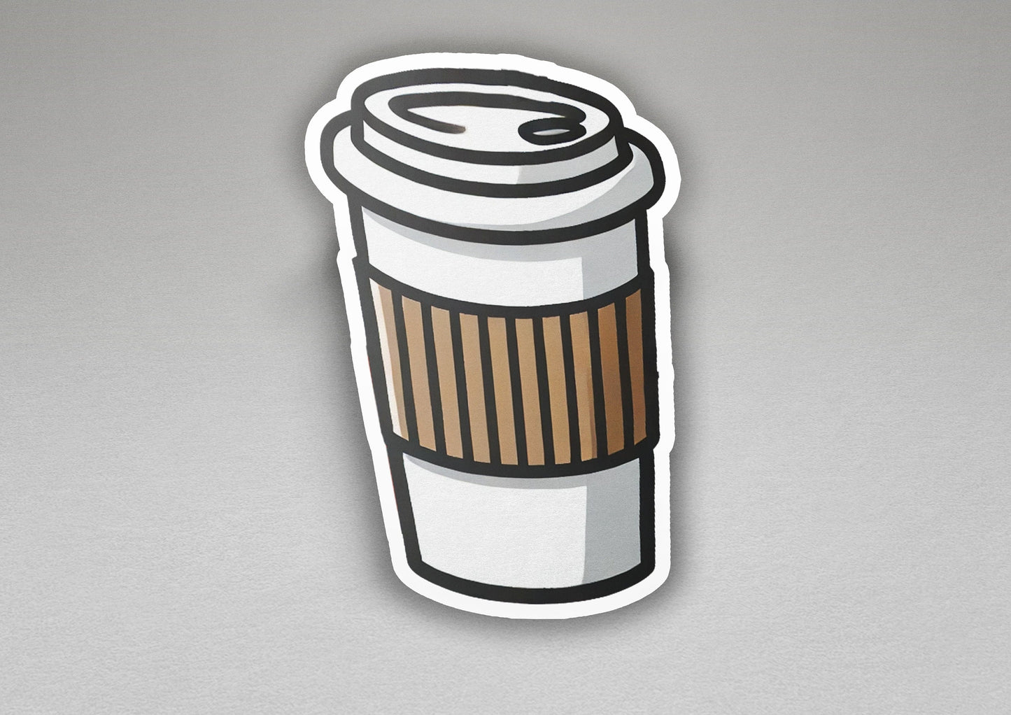 a sticker of a coffee cup on a gray surface