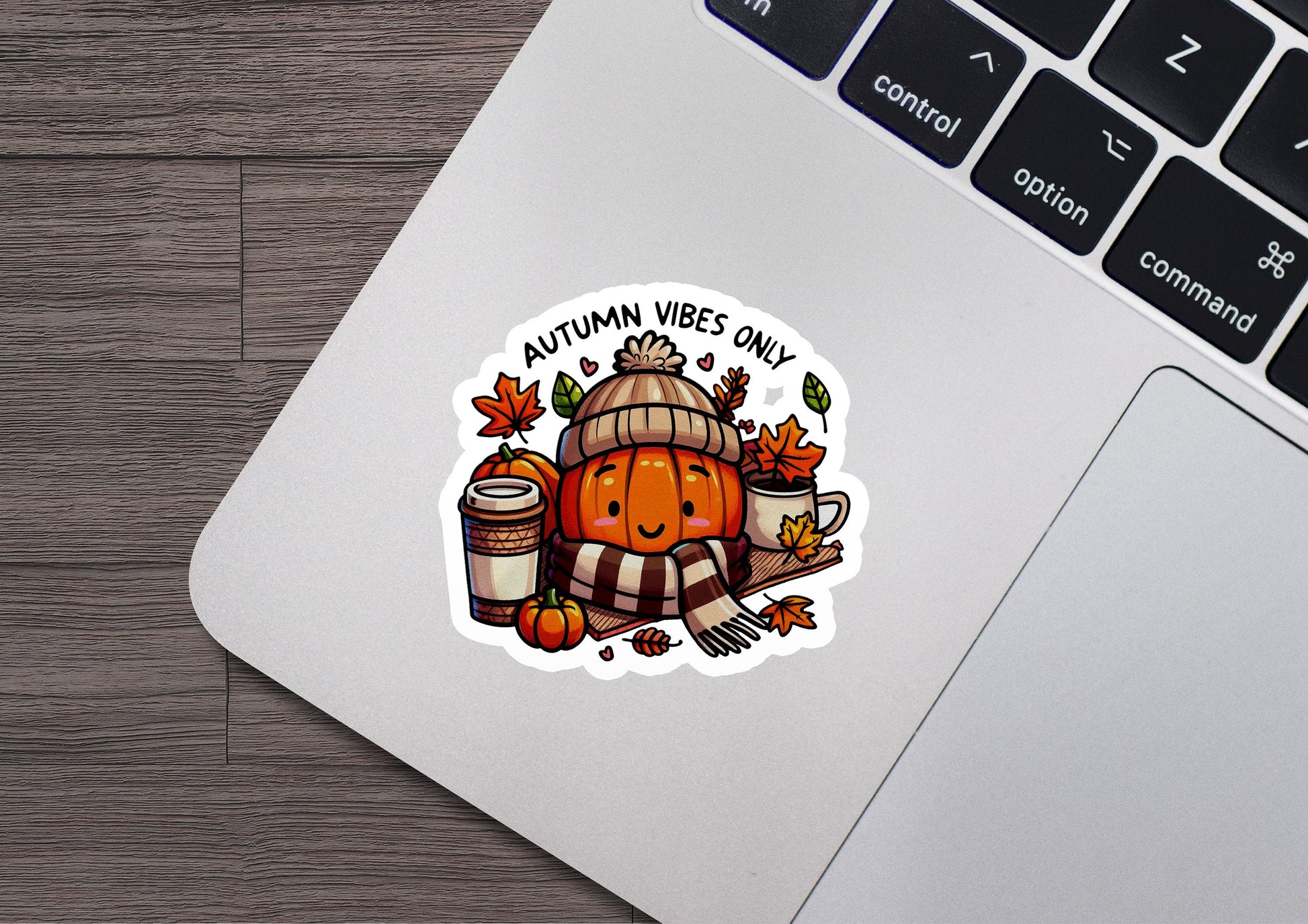 a laptop with a sticker of a pumpkin and a barrel of coffee