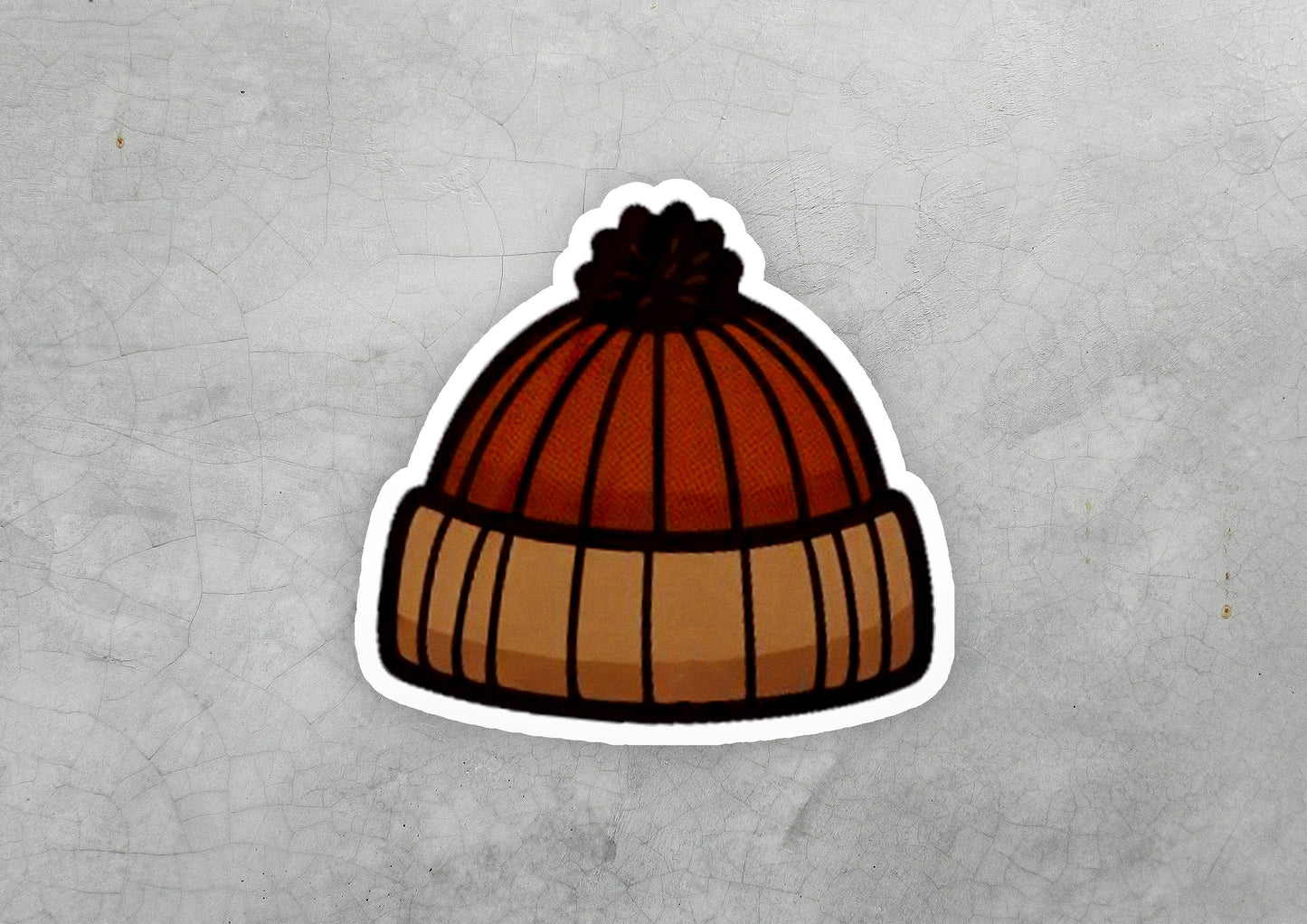 a sticker of a beanie on a concrete surface